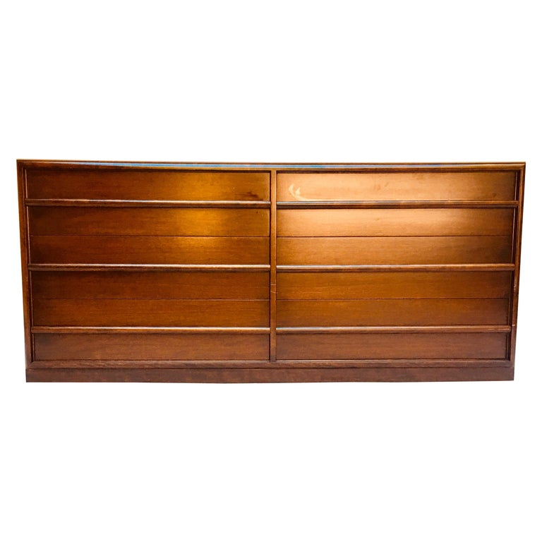 A six-drawer dresser designed by T.H. Robsjohn-Gibbings for Widdicomb, from the 1950s. 
The walnut dresser is in its original Espresso lacquer that has been conserved not refinished and is in excellent vintage condition.
It has its original