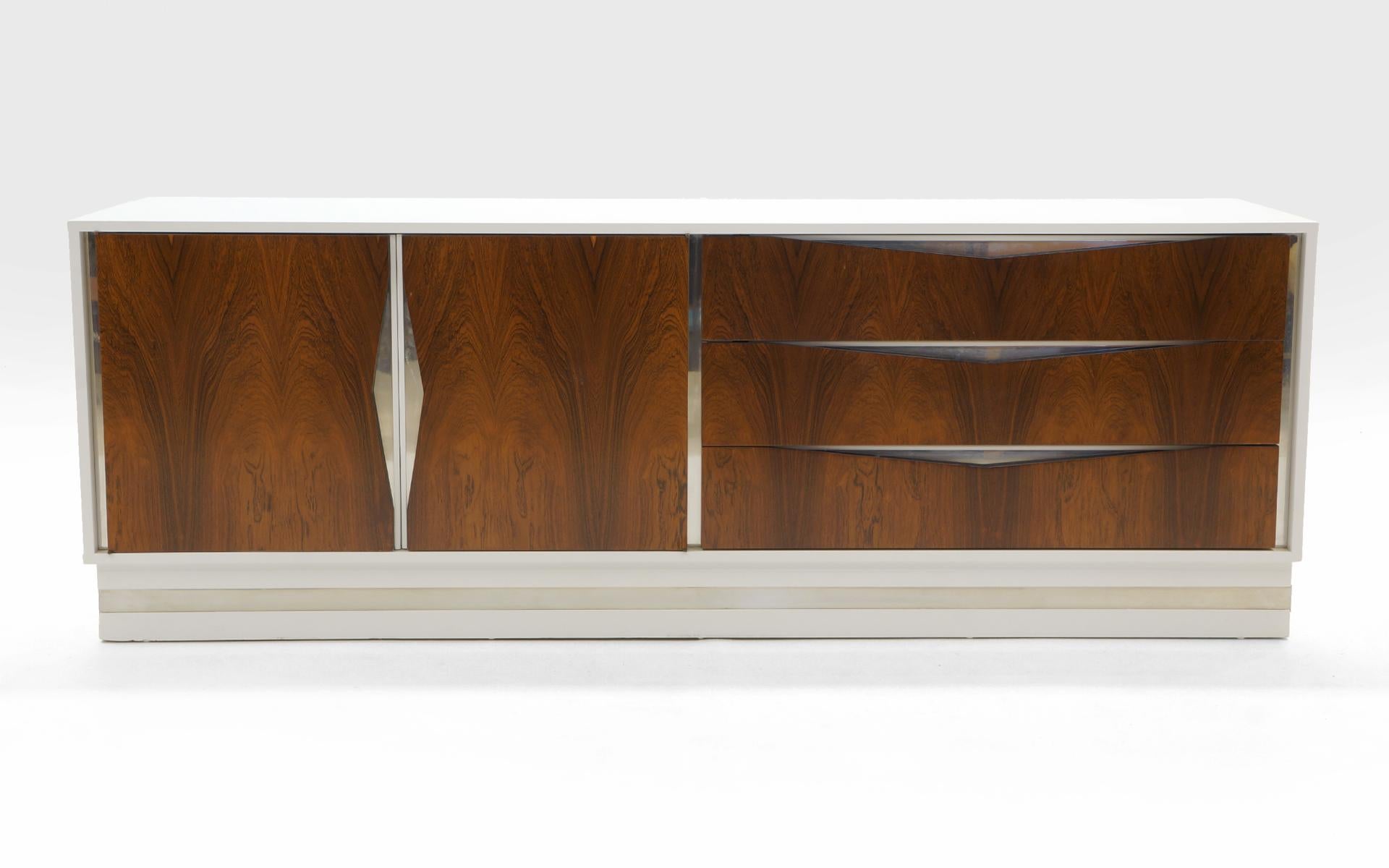 Stunning white, rosewood and chrome dresser attributed to Milo Baughman. We also have a listing for the matching nightstands. This cabinet has been expertly restored with a white conversion varnish finish (better than lacquer). The rosewood and