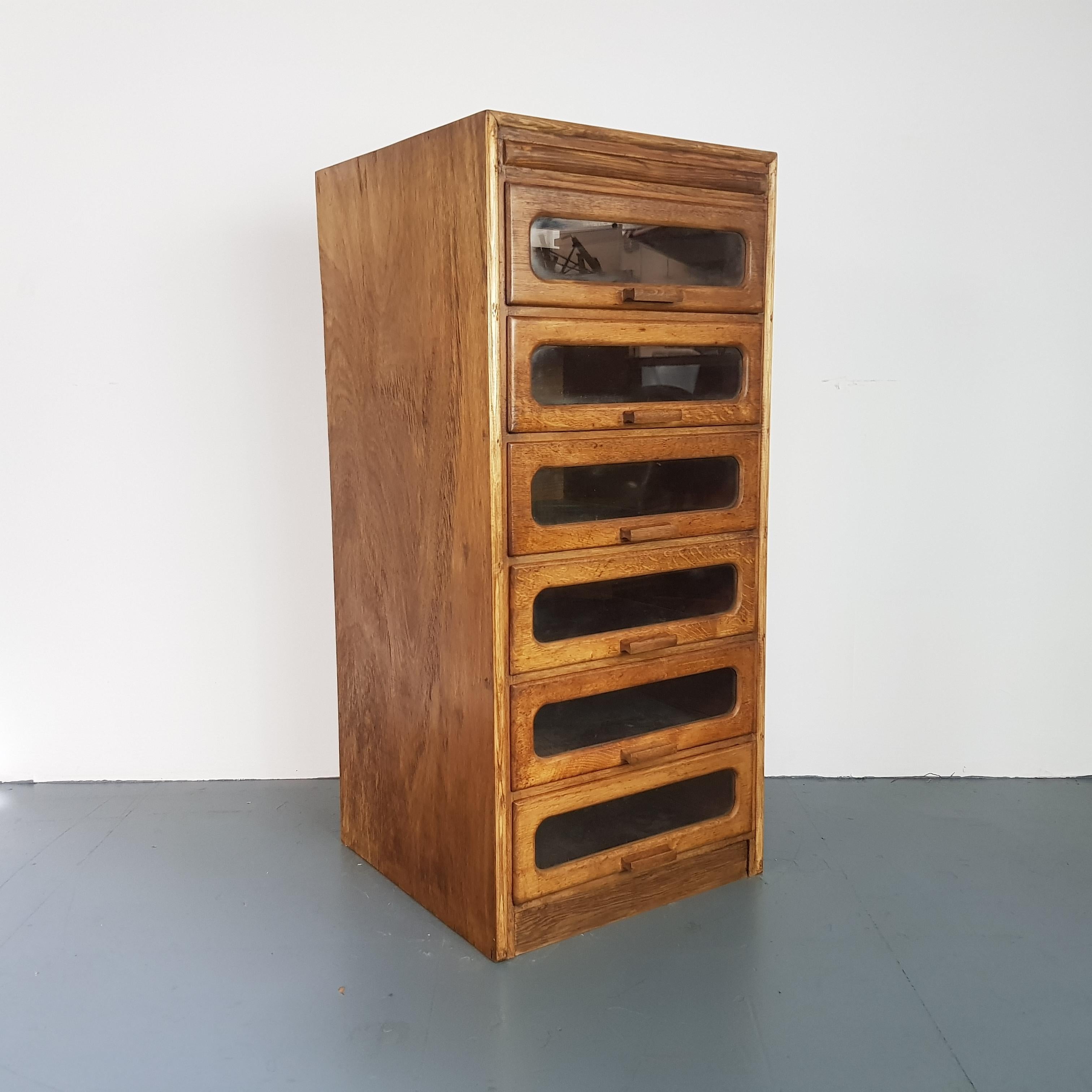 6-drawer single column haberdashery shop cabinet. 

It has 6 glass fronted drawers, all with original wooden handles.

Approximate dimensions:

Height: 107cm

Width: 49cm

Depth: 50cm

Drawers: 40cm x 45cm x 12cm.

 

Overall, in