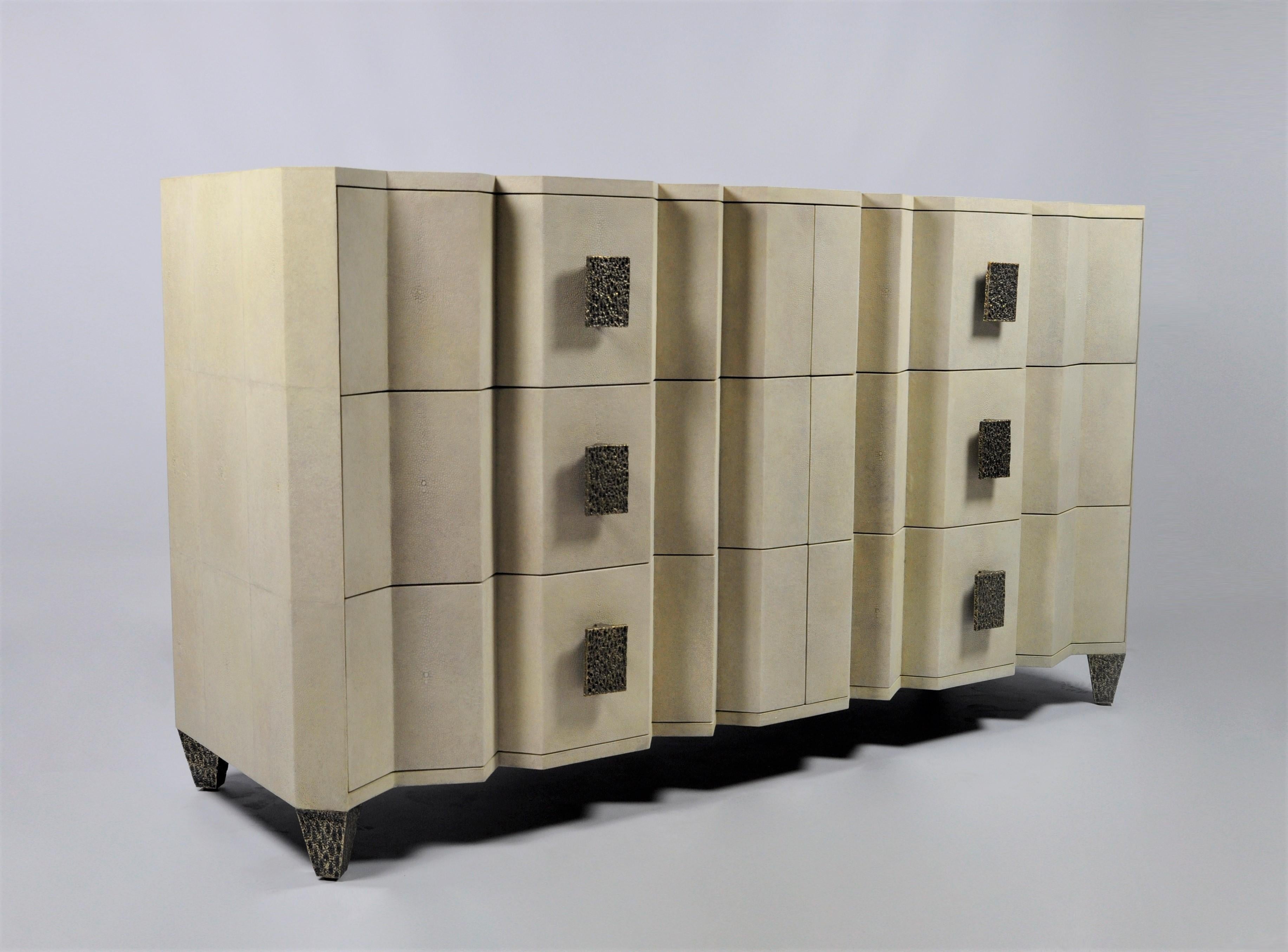 The Accordeon dresser is a stunning futurist piece made of shagreen. It has six drawers.
The handles and the feet are made in lost wax cast brass with a bronze patina.
The interior of the drawers are in black veneer.

The dimensions of this dresser