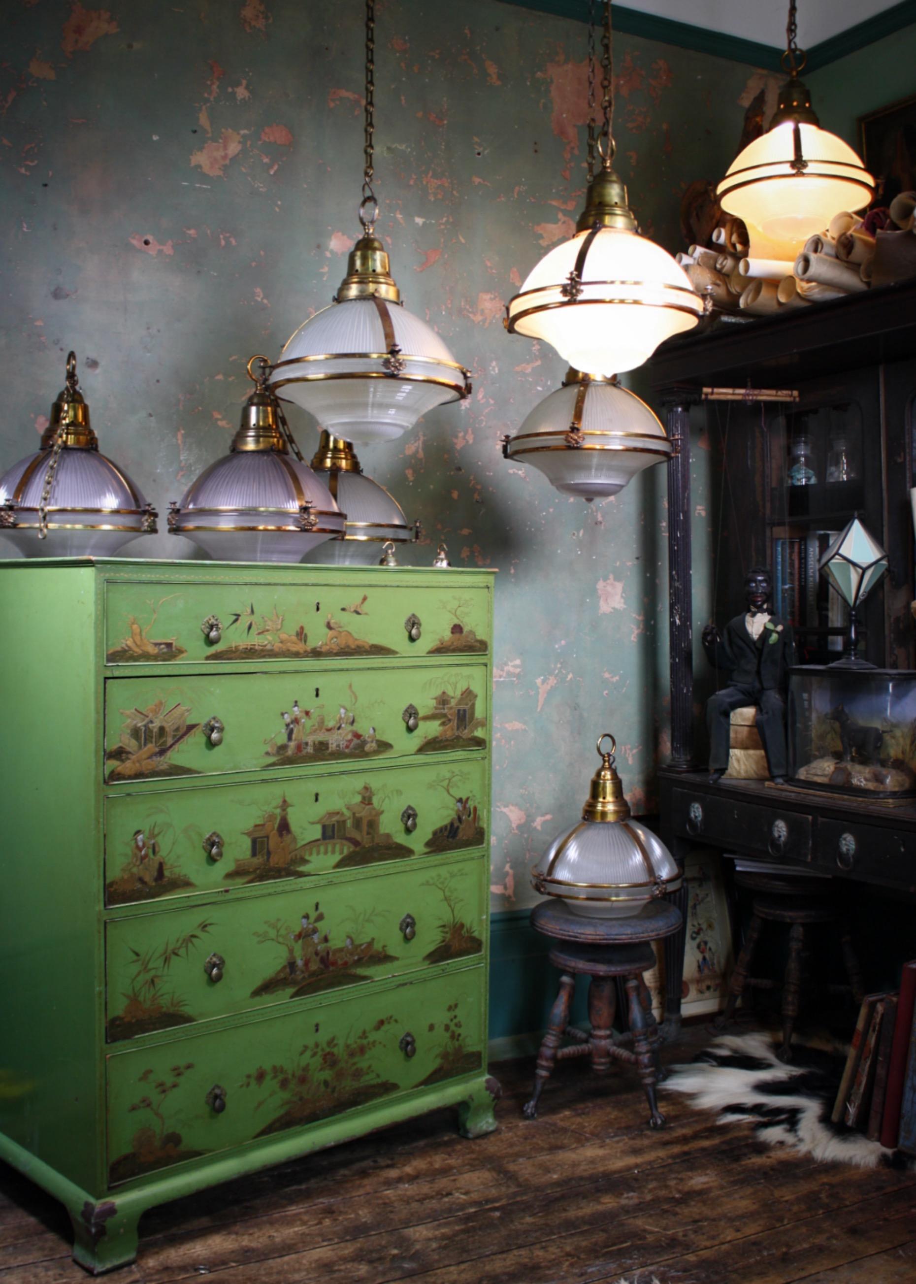 A very good run of six extra large three part prismatic glass Holophane lanterns, housed within their original elaborate gilt copper cages.

The gilt copper (over brass) has a wonderful patina, with the finish over time almost turning into a rose