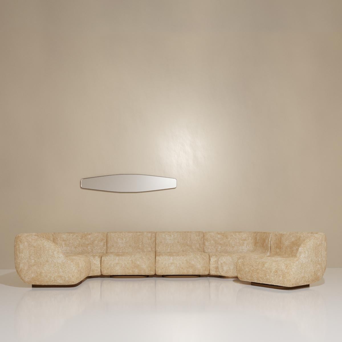 Le Canapé U - or modular U-sofa is a master of disguise. Six primary elements, each with an independent hand patinated brass base, combine to create a classic U-shaped design. The end elements detach and function as independent lounge chairs with