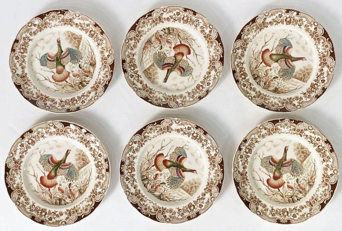 A set of six dinner plates featuring the Wild Turkey - Flying brown and white transfer-ware pattern by the celebrated English pottery firm, Johnson Brothers.

With authentic midcentury brown label on reverse - preferred by collectors.

Perfect