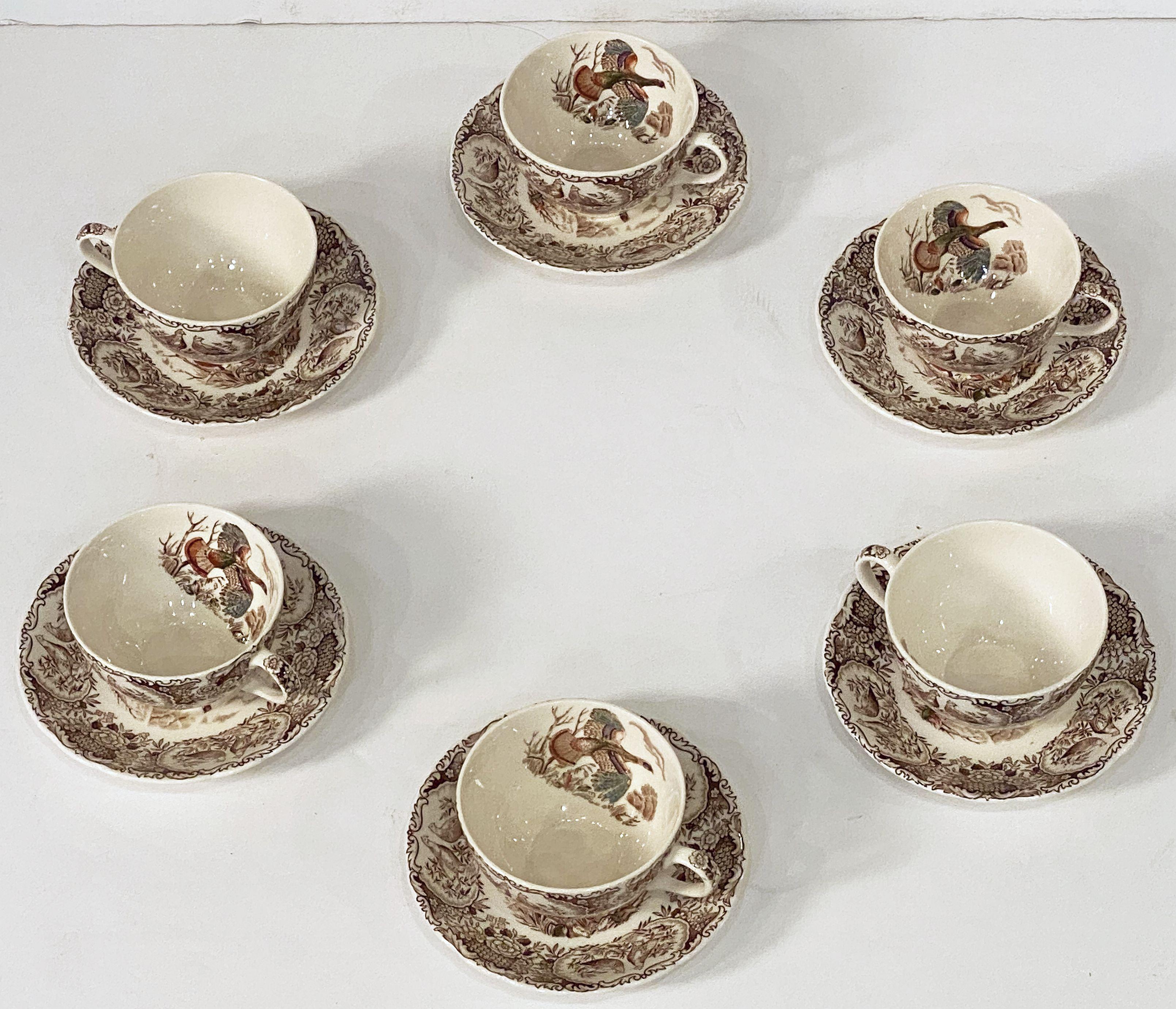 A set of six cups and saucers featuring the Wild Turkey - Flying brown and white transfer-ware pattern by the celebrated English pottery firm, Johnson Brothers.

With authentic midcentury brown label on reverse - preferred by