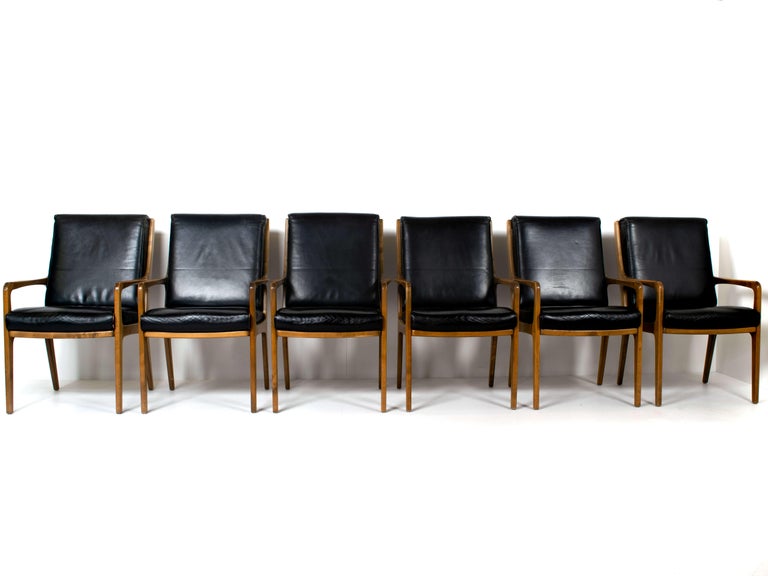 Six Eugen Schmidt high-back conference or office chairs in leather and wood. Sophisticated chair with robust look. It has armchairs on both sides and the high-back slightly leans backwards. They sit very comfortable, ideal for long conferences,