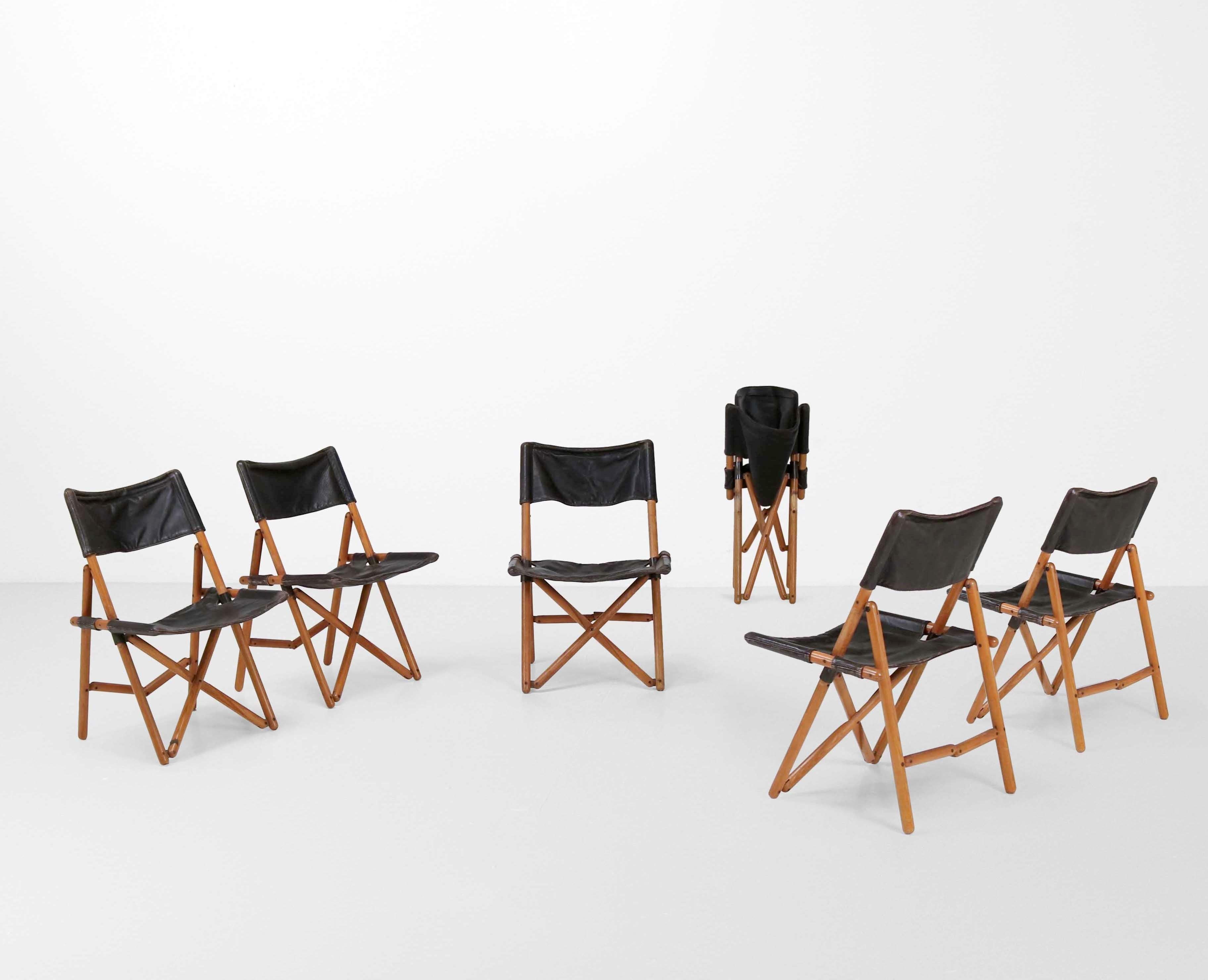 
These Six Folding Chairs model Navy by Sergio Asti represents a Italian Design finesse. Crafted for Zanotta in 1969, these chairs feature wooden structure complemented by metal detailing and luxurious leather seating and backs. Asti's minimalist