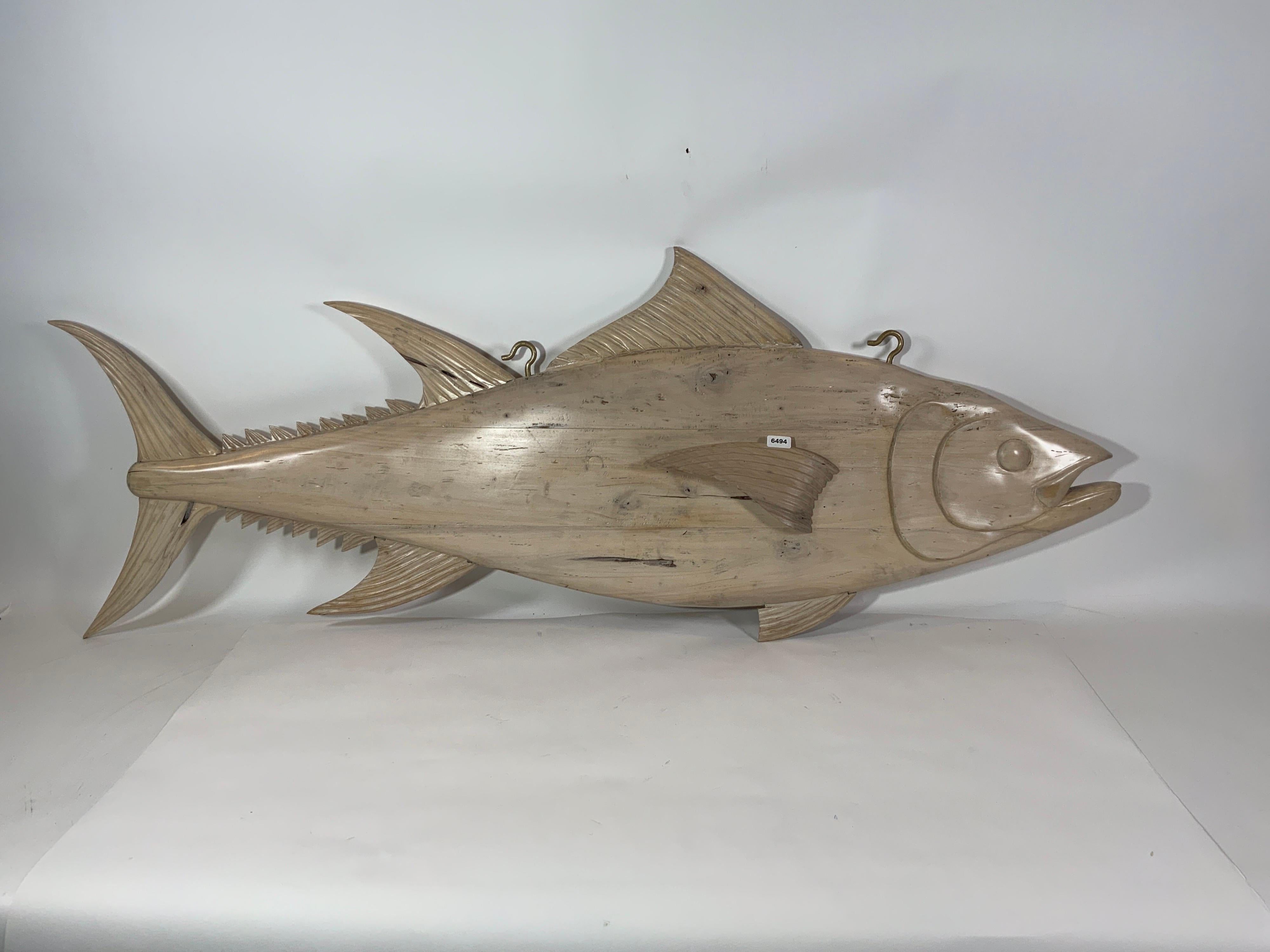 Finely carved tuna fish trade sign with pickled finish. Carved from solid timber with fins, gills, eyes and snout. Fitted with hanging hooks.

Overall Dimensions: Weight is 35 pounds. 26