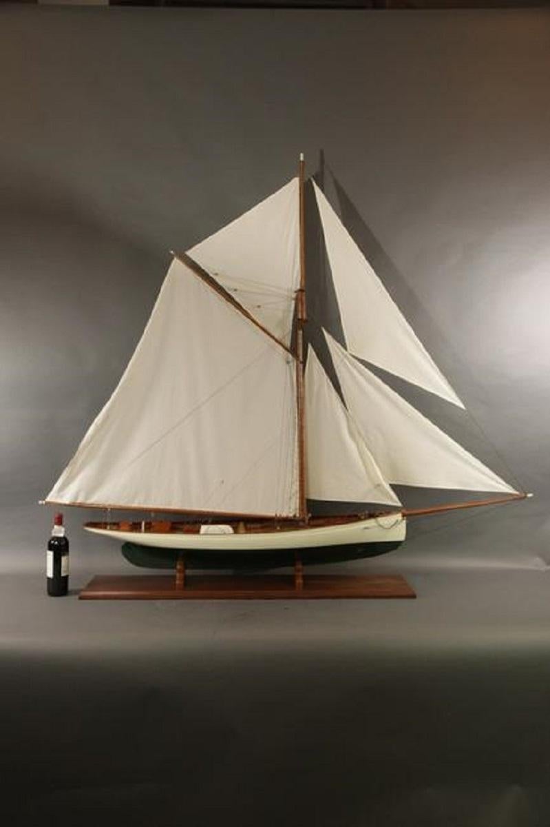 Six foot model of the Boston built America's Cup yacht Puritan. Fine model with planked deck, skylights with brass bars, suit of sails, etc. Mounted on a mahogany baseboard.

Overall Dimensions: 64
