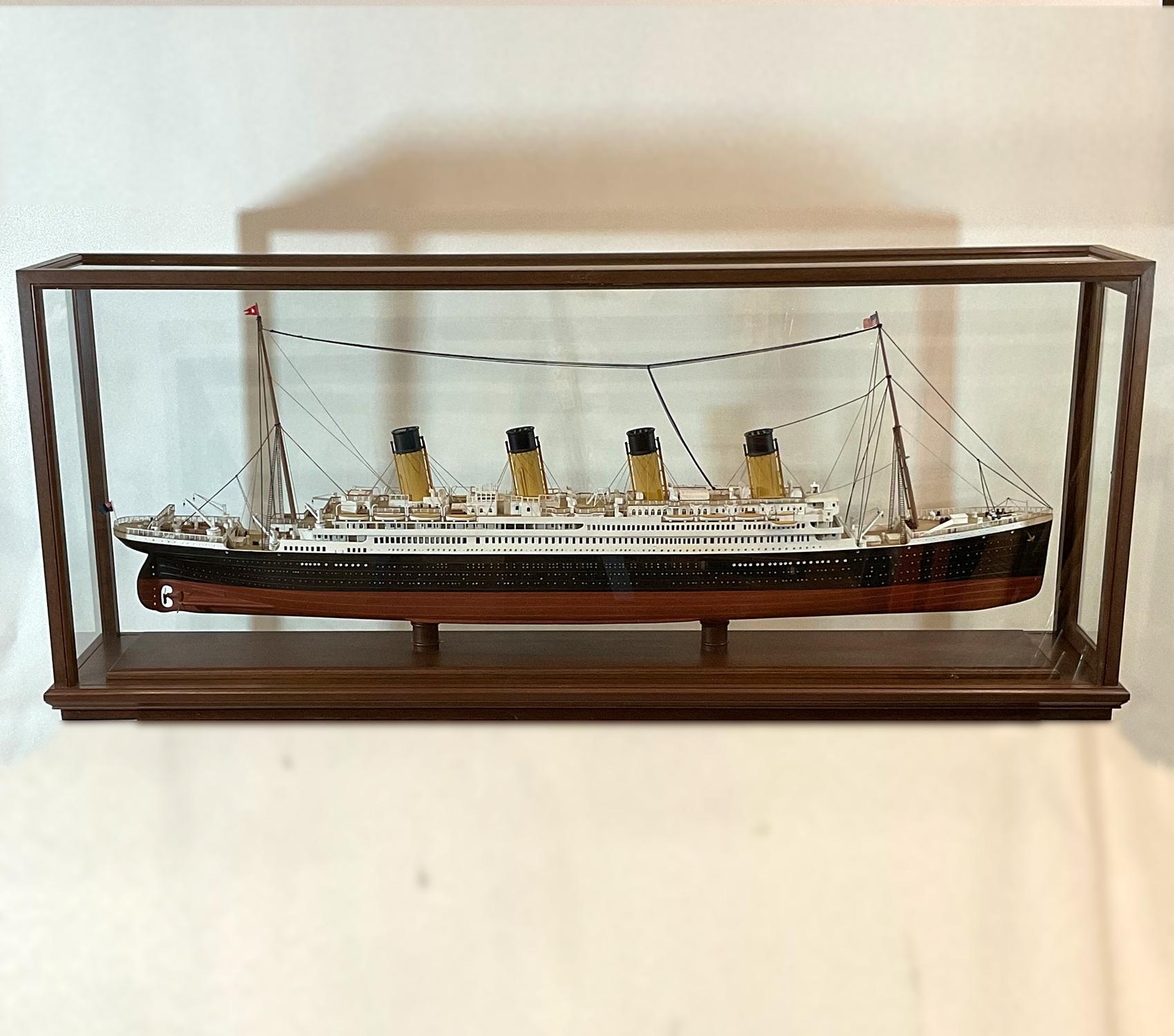 Fine cased model of the white star liner “Titanic”. Well executed model of the classic and famous four stack liner. Details include lifeboats, cargo booms, skylights, cabins, railings, winches, chains, anchors, benches, etc. Fitted to a glass