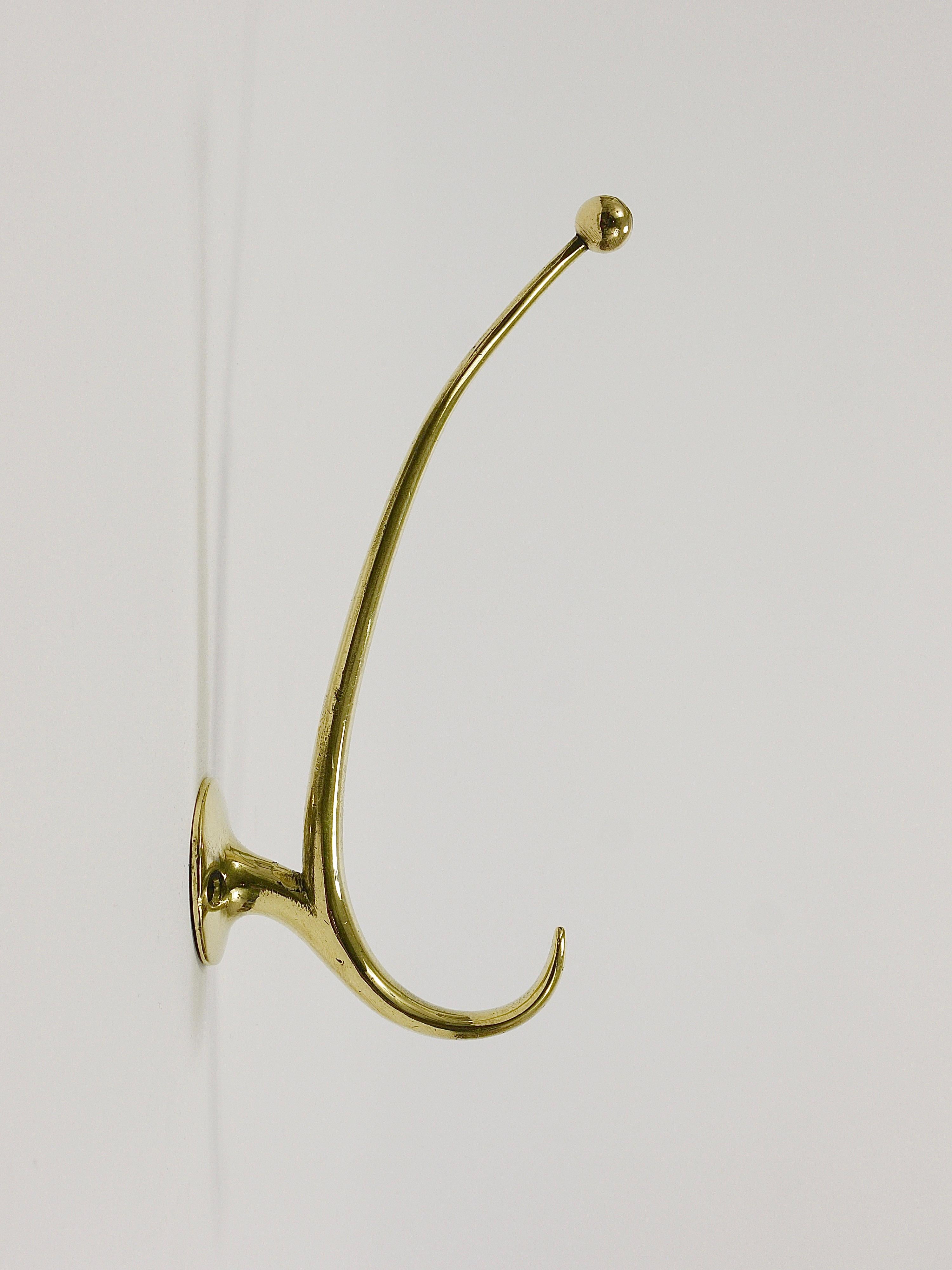 A collection of up to six vintage sleek and elegant Mid-Century wall coat hooks, designed by Franz Hagenauer and crafted by Werkstätte Hagenauer in the early 1950s. Sold individually and priced per piece. These hooks are handcrafted from solid