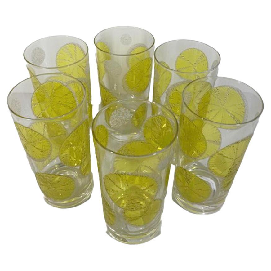 Set of six Mid-Century Modern highball glasses by Fred Press, decorated with translucent yellow enamel lemon slices accented with textured, raised white sugaring .