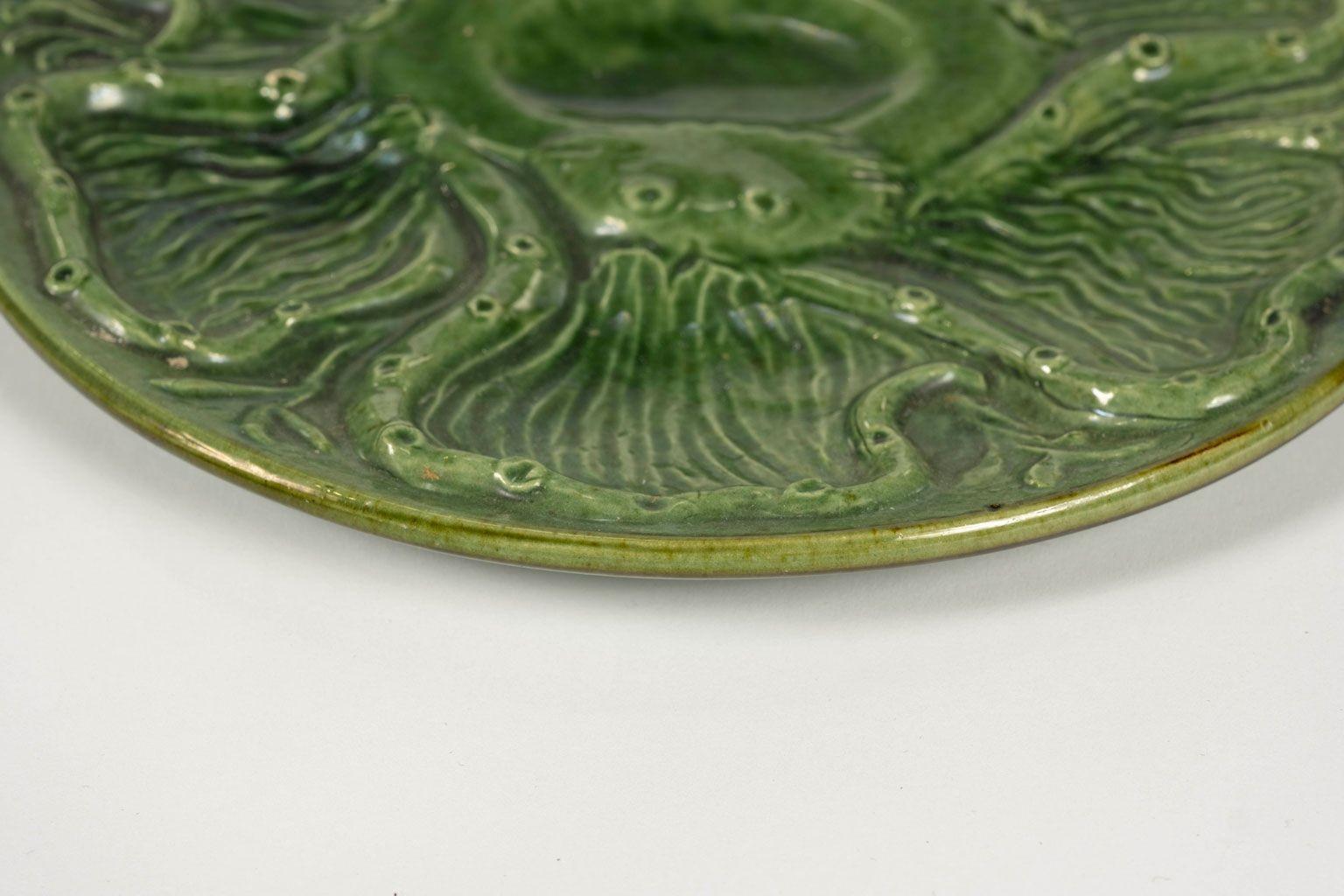 Six French green Majolica oyster plates in octopus pattern circa 1950. Marked Aegitna Vallauris in Southern France. Sold together. Priced $1,800 set of six.