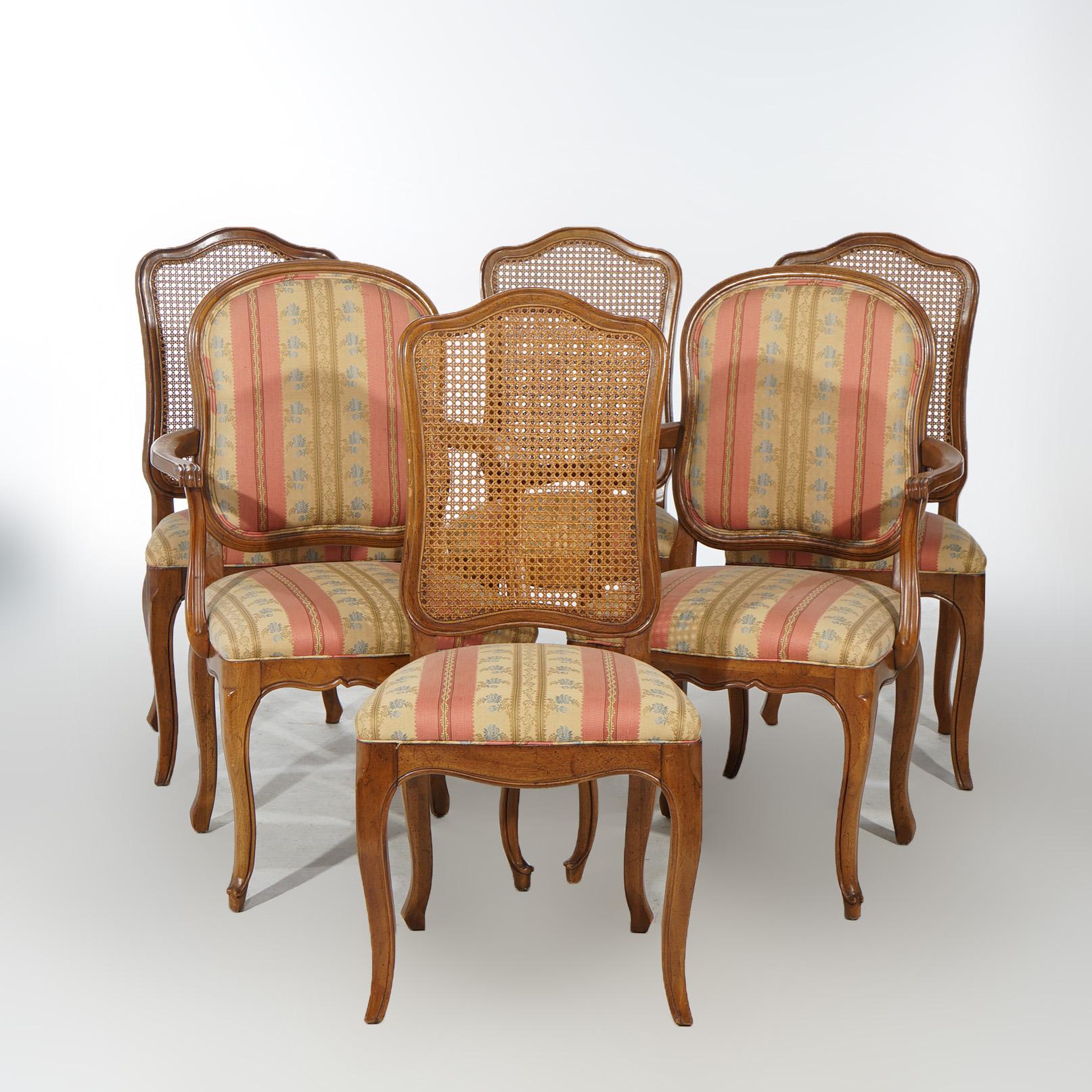 A set of six dining chairs offer mahogany construction and having shaped backs with upholstered seats raised on cabriole legs; set includes four side chairs with caned backs and two armchairs with upholstered backs; 20th century.

Measures -