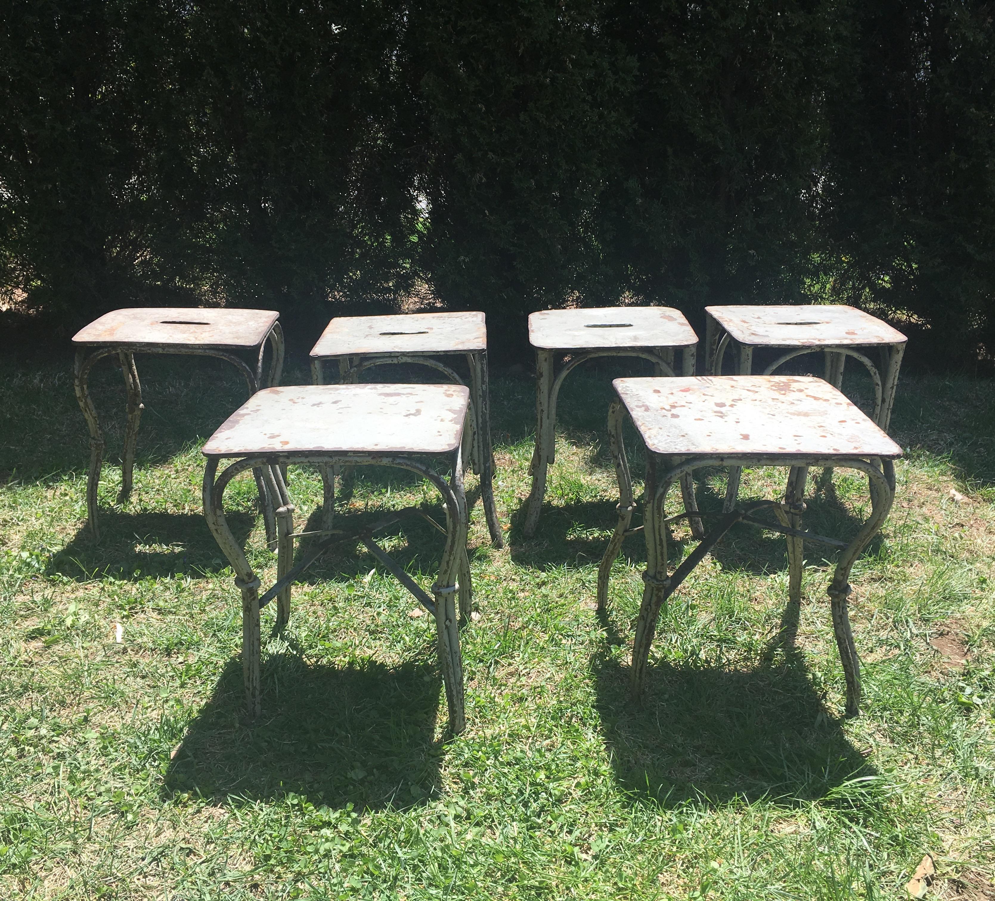 These wonderful little garden stools or side tables were handmade in the late 19th or early 20th century and they are beautifully-crafted. Two have solid tops and slightly different, more elaborate legs, while four have tops with slots (to let the