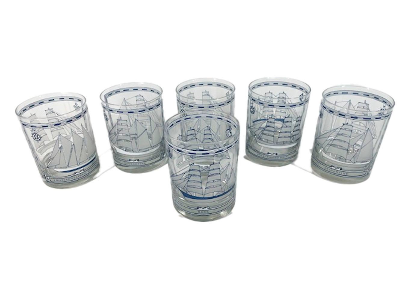 Six mid-century rocks glasses designed by Georges Briard, in blue and white enamel. Each glass with two sailing ships of different types with the type named below the image. Included are bark, full-rigged ship, 3 masted staysail schooner, brig,
