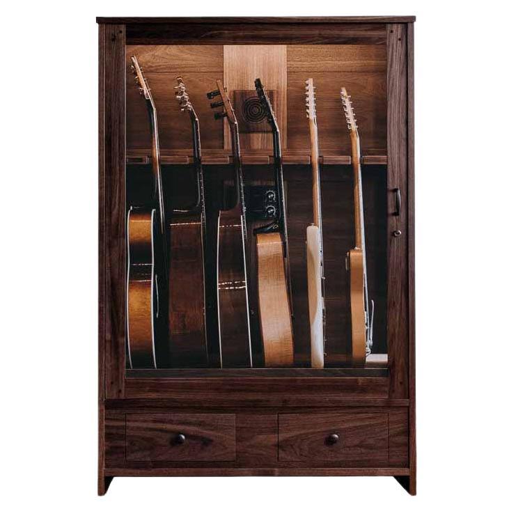The Guitar Habitat is a handcrafted solid wood cabinet and guitar humidor designed to display acoustic and electric guitars in an easily accessible & elegant five-guitar display. This humidified guitar display cabinet includes a 1-gallon guitar