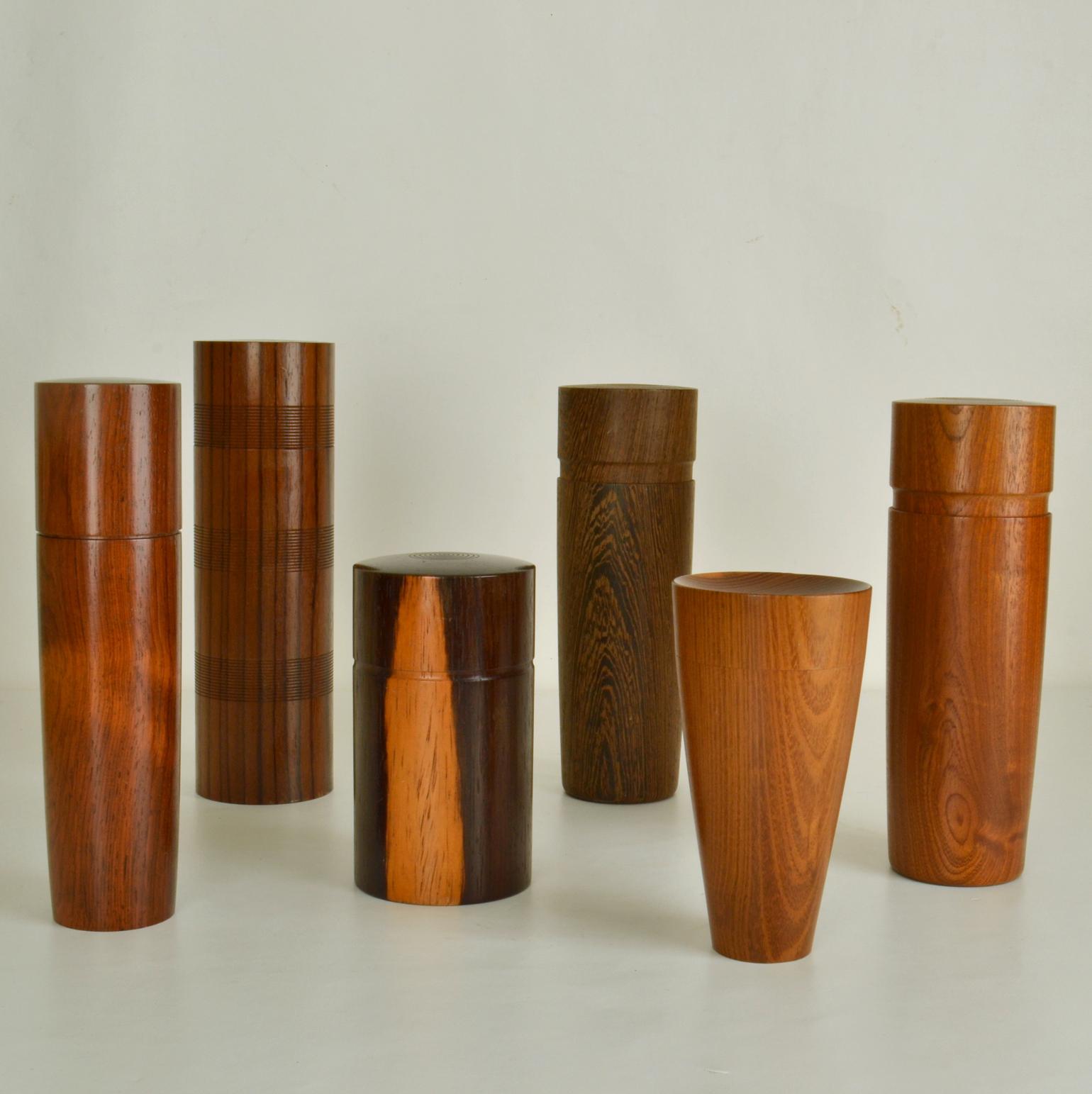 Set of six refined hand turned wooden boxes each in a different specimen in straight and tapered cylinder shape in various heights showing excellent craftsmanship. The grain and patterns of the wood match up perfectly between the thin walled box and