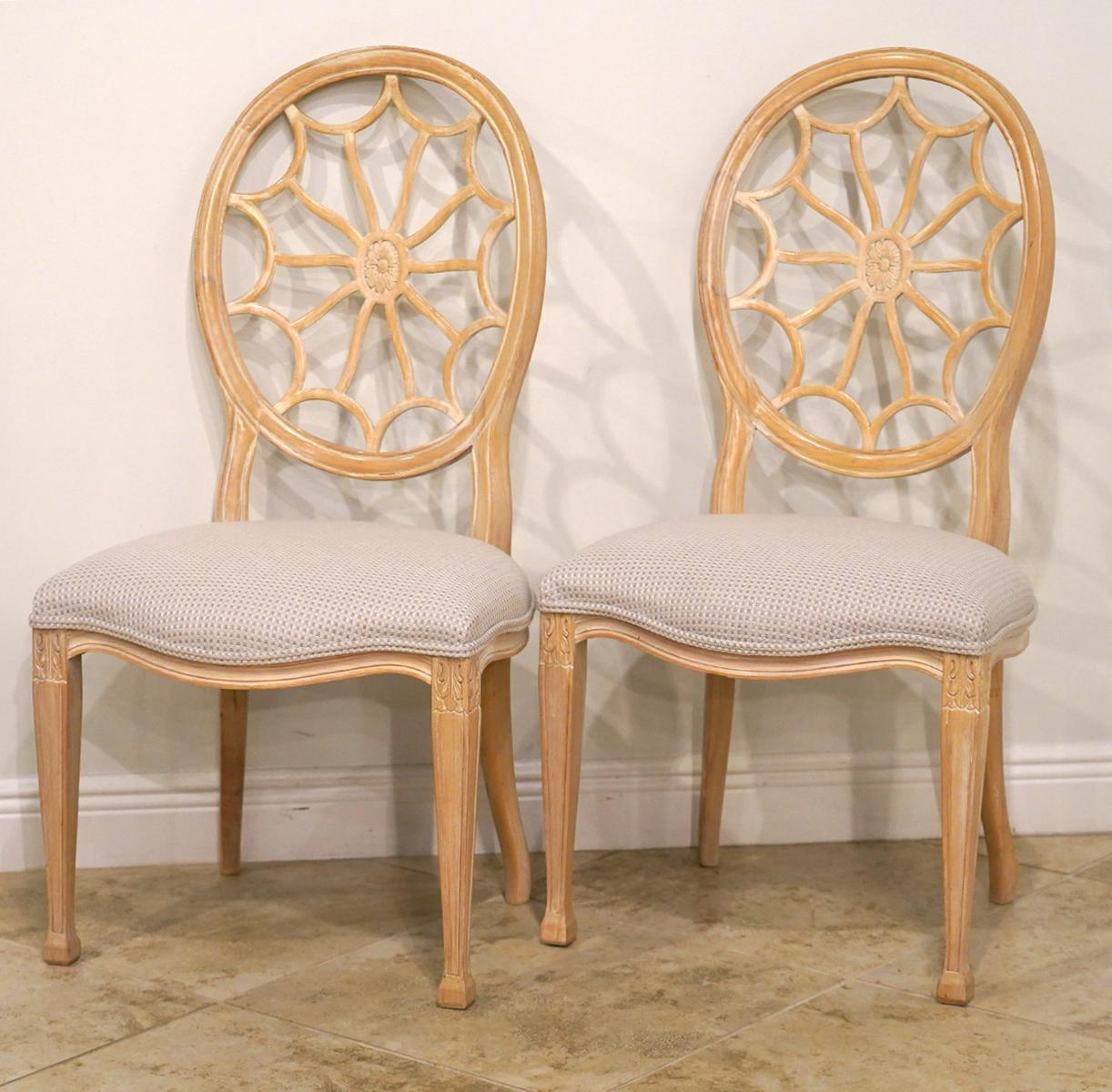 Beautifully carved antique white painted frameworks featuring round backrests and soft shaped spiderweb splats. The serpentine front seats are well upholstered and tastefully covered. Square tapered and carved legs with stylized spade feet