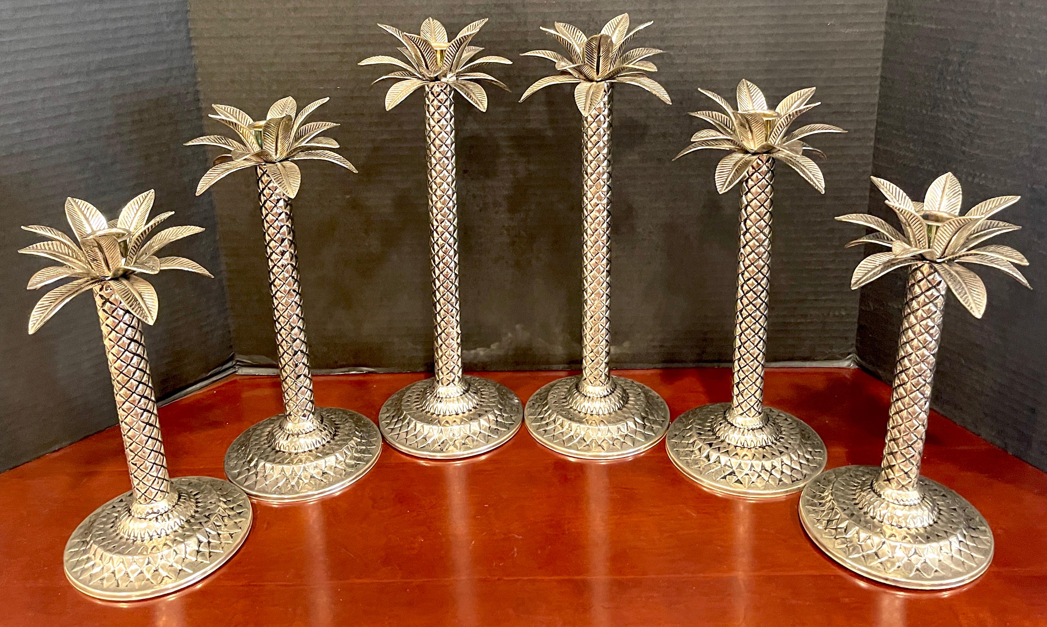 Six Hollywood Regency style silverplated palm tree candlesticks
Consisting of three pairs of tapering realistically cast and modeled pairs of palm tree candlesticks.
The tallest pair is 14