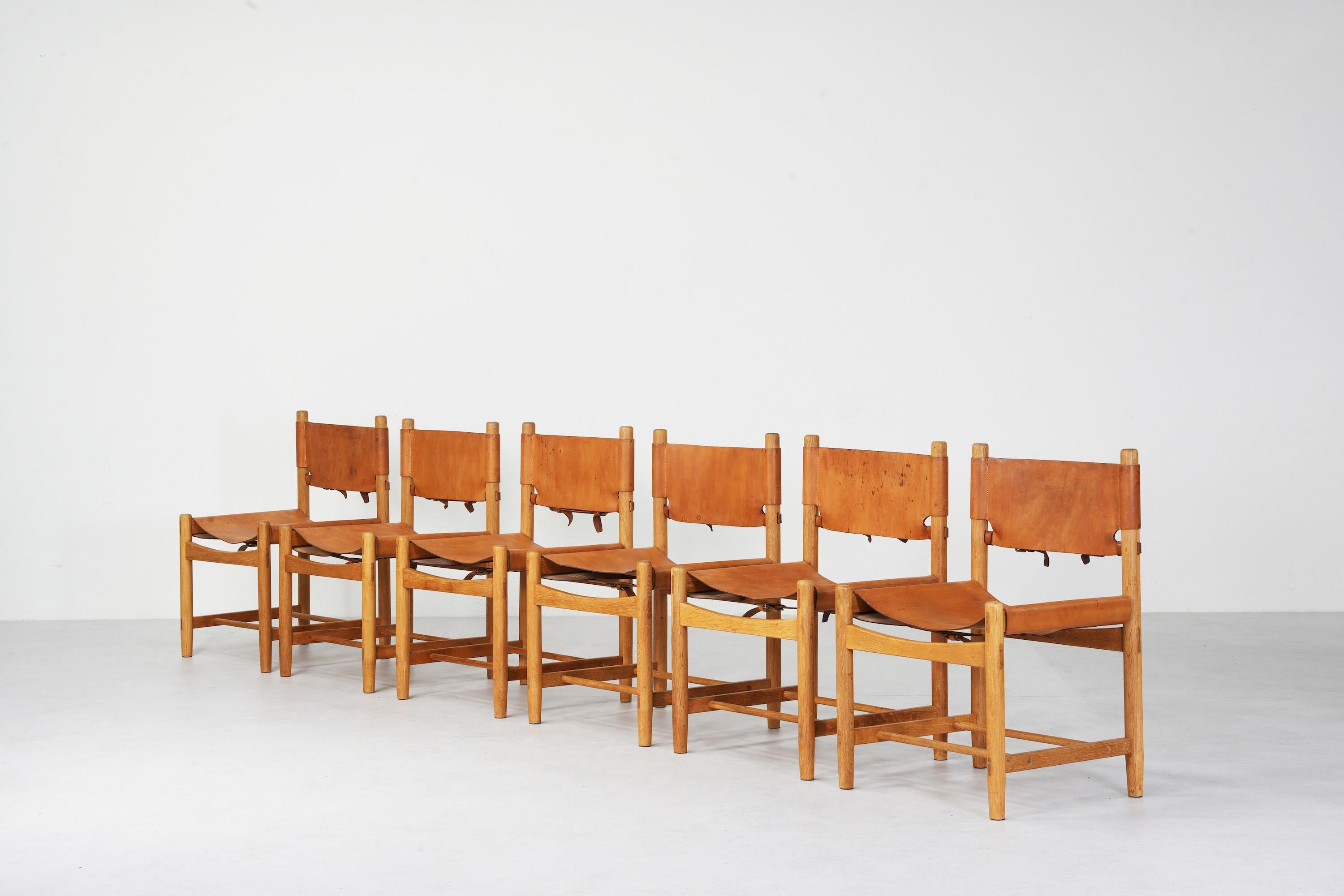 Beautiful set of six 'Hunting' chairs, probably the oldest version of model no. 3237 and attributed to Børge Mogensen and Fredericia Furniture, Denmark. 
All six chairs come with great patinated leather in brown cognac and a beautifully aged oak