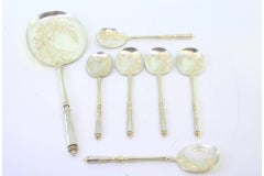 Six ice-cream scoops and shovel in gilt silver with floral-engraved shells