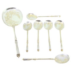Six ice-cream scoops and shovel in gilt silver with floral-engraved shells