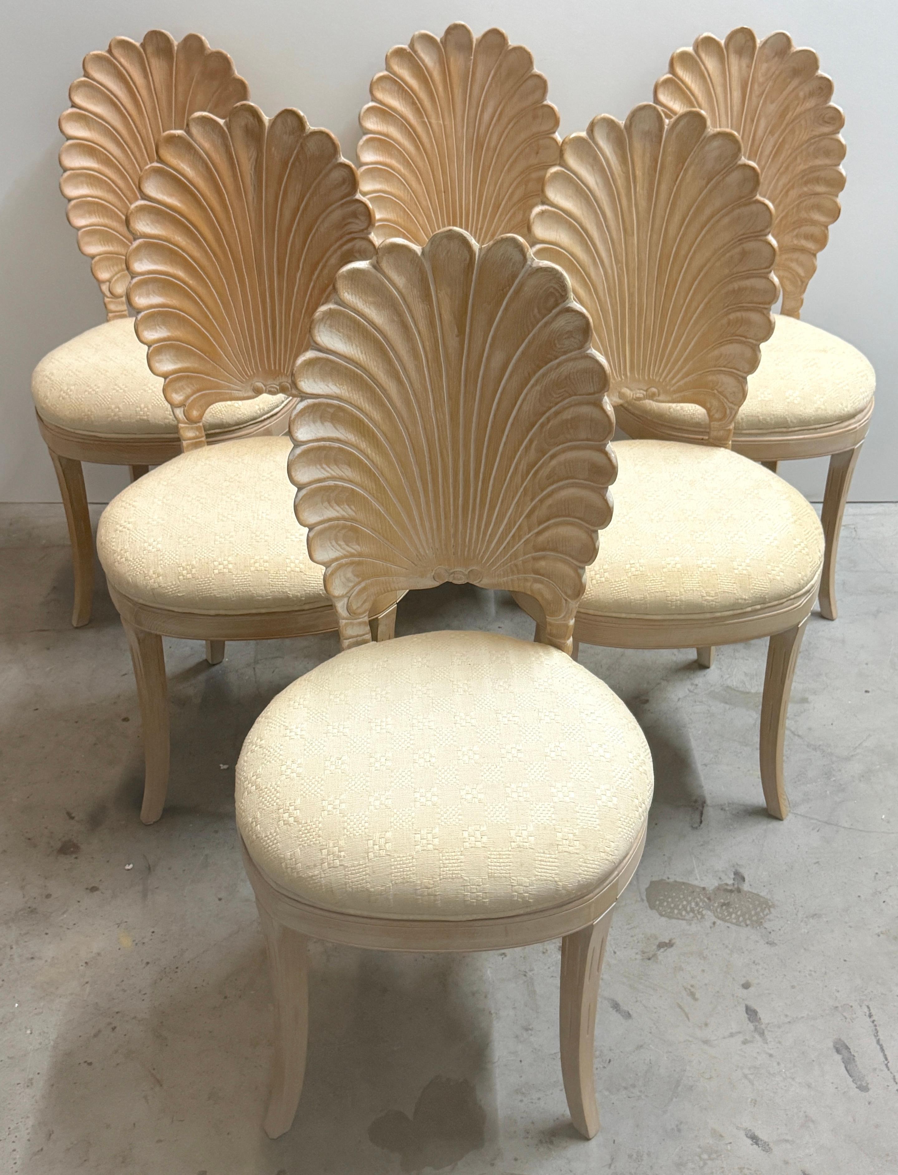 Set of Six Italian Carved Wood Hollywood Regency Grotto Chairs, circa 1980

An exceptional set of six Italian carved wood Hollywood Regency grotto chairs, circa 1980, distinguished by their dramatic scallop shell backs and refined coastal glamour.