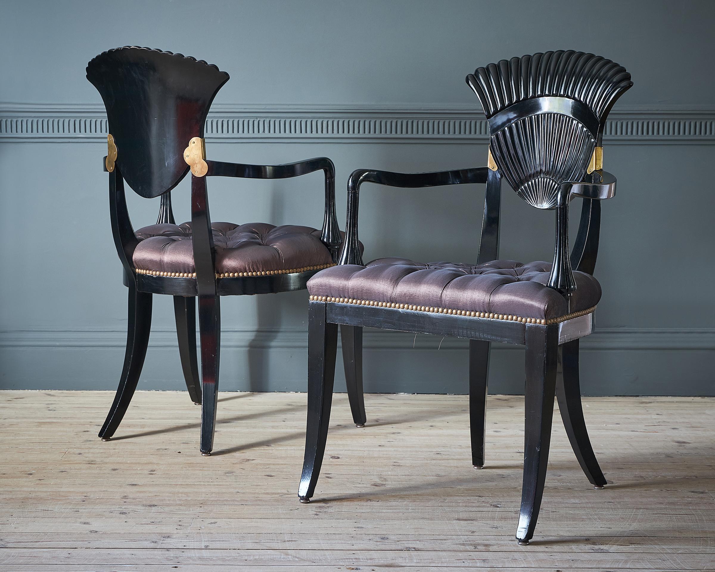 A set of six continental ebonized wood dining chairs, probably Italy, circa 1940. 
The back form of scalloped shell, with gilt in deep mauve buttoned silk.