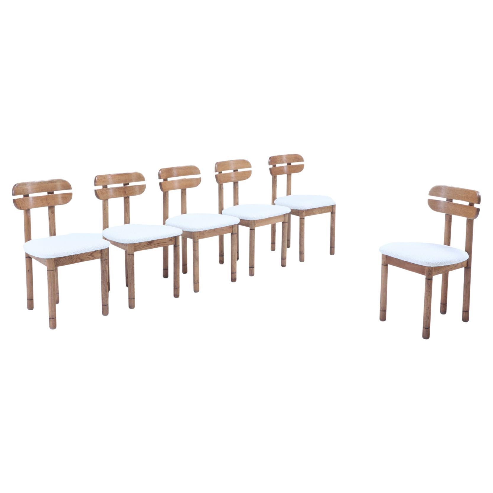 Six Italian oak dining chairs C 1965 reupholstered in a white boucle fabric For Sale