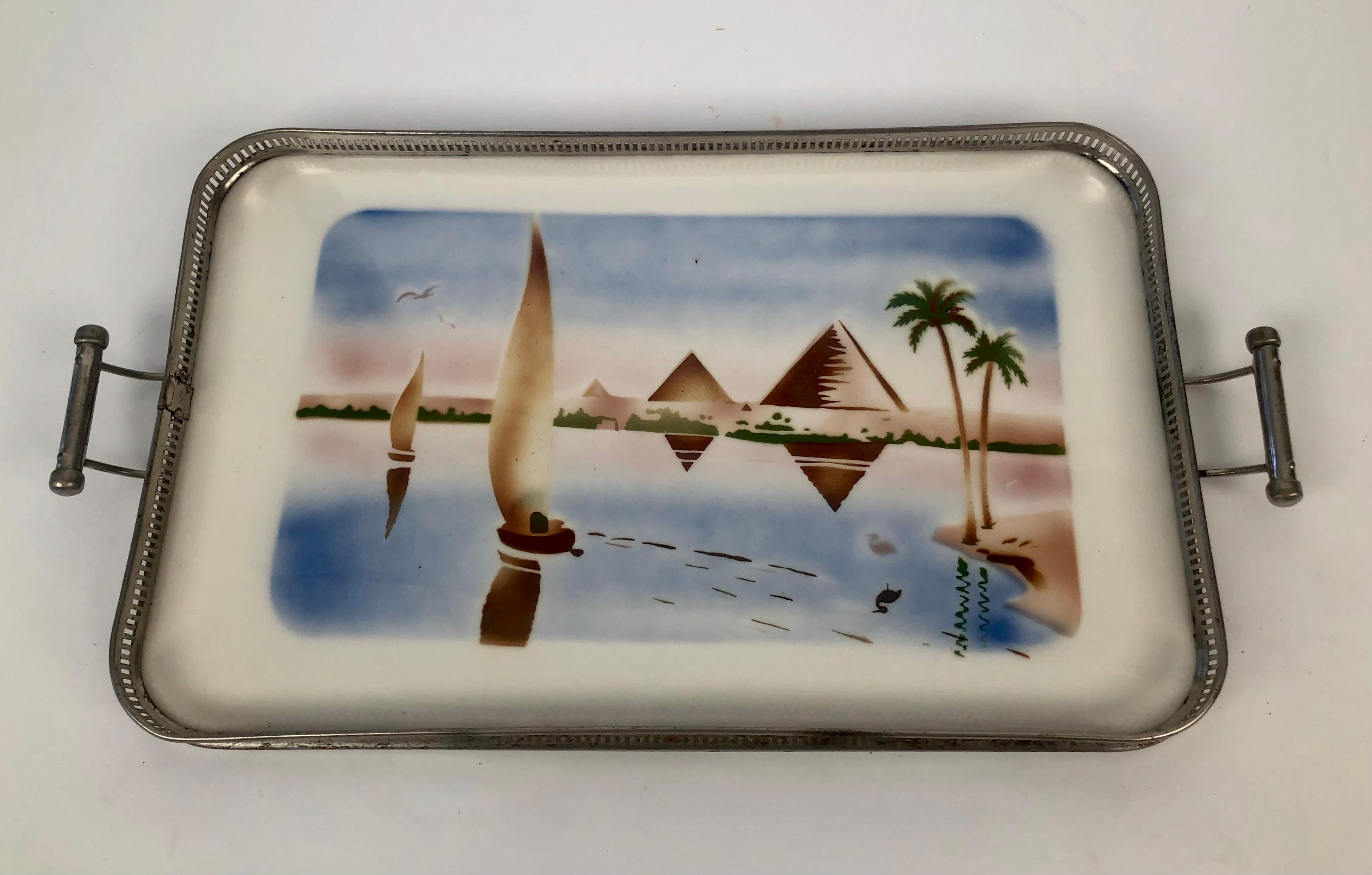 A set of six Jugendstil ceramic trays with metal frames depicting scenes from the near east.
Some of the metal frames have accumulated rust  to varying degrees from very rusty
to small amounts of rust There is no structural damage.

Shipping costs