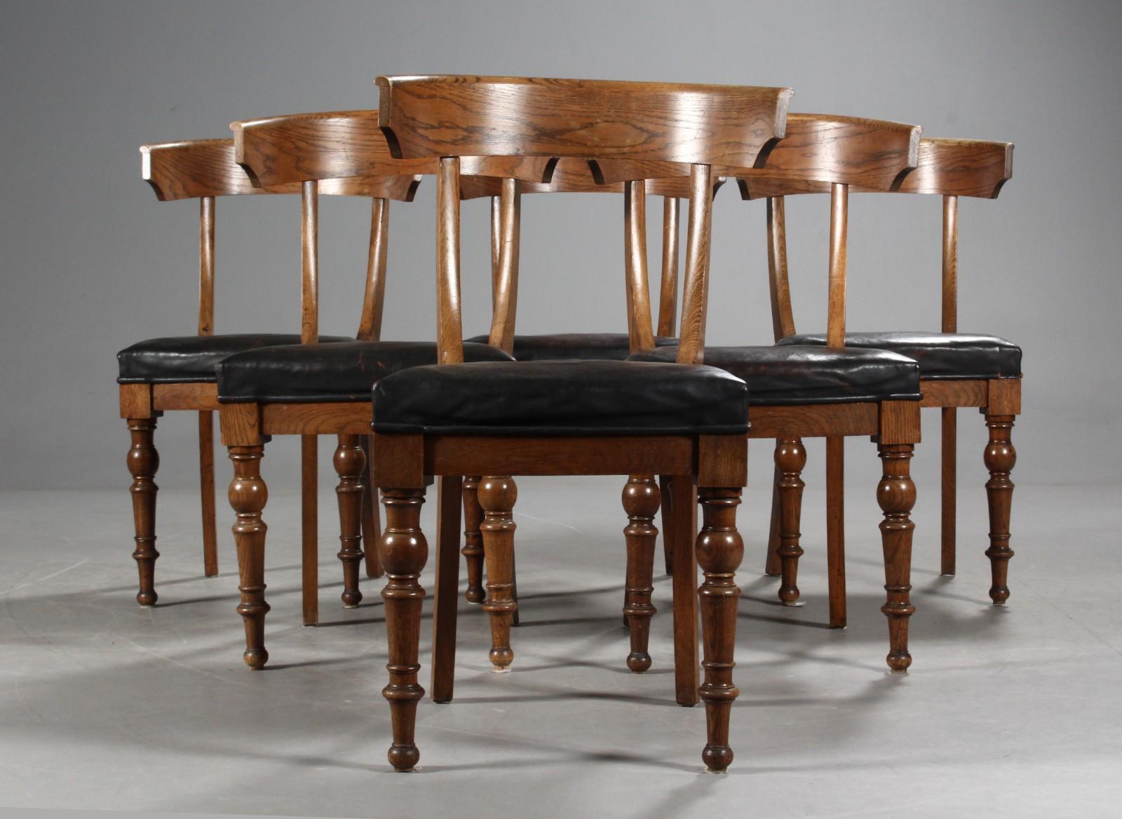 Set of 6 Klismos-style dining chairs in oak with seats covered in black fabric and turned front legs and sabre back legs, circa 1900.