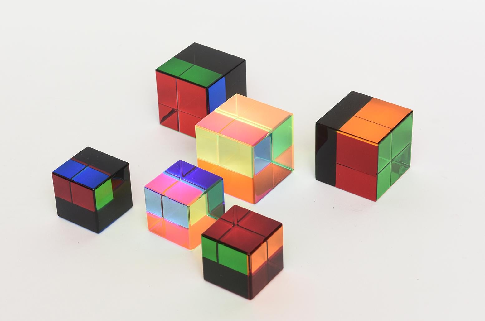 This set of 6 Vasa Mihich very colorful laminated lucite cubes are a combination of sizes. One of 3 large cubes is signed Vasa 2020 and one of the 3 small cubes is signed Vasa 2017. Their colors change with every plane of light and different angle