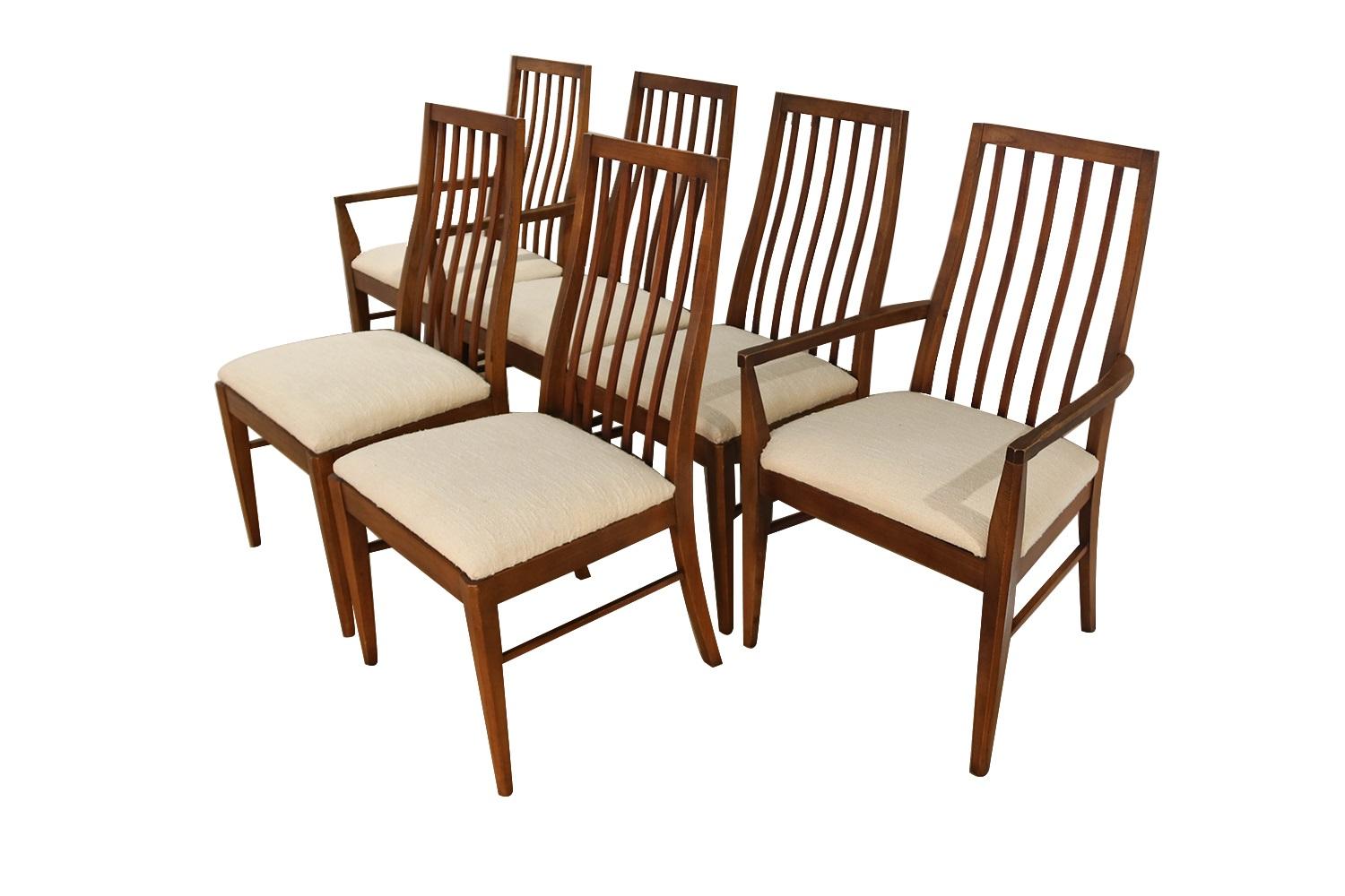An absolutely stunning set of six Mid-Century Modern Lane First Edition dining chairs manufactured by Lane Furniture. These gorgeous chairs feature beautifully sculpted walnut frames with spindle curved backs providing lumbar support, making these
