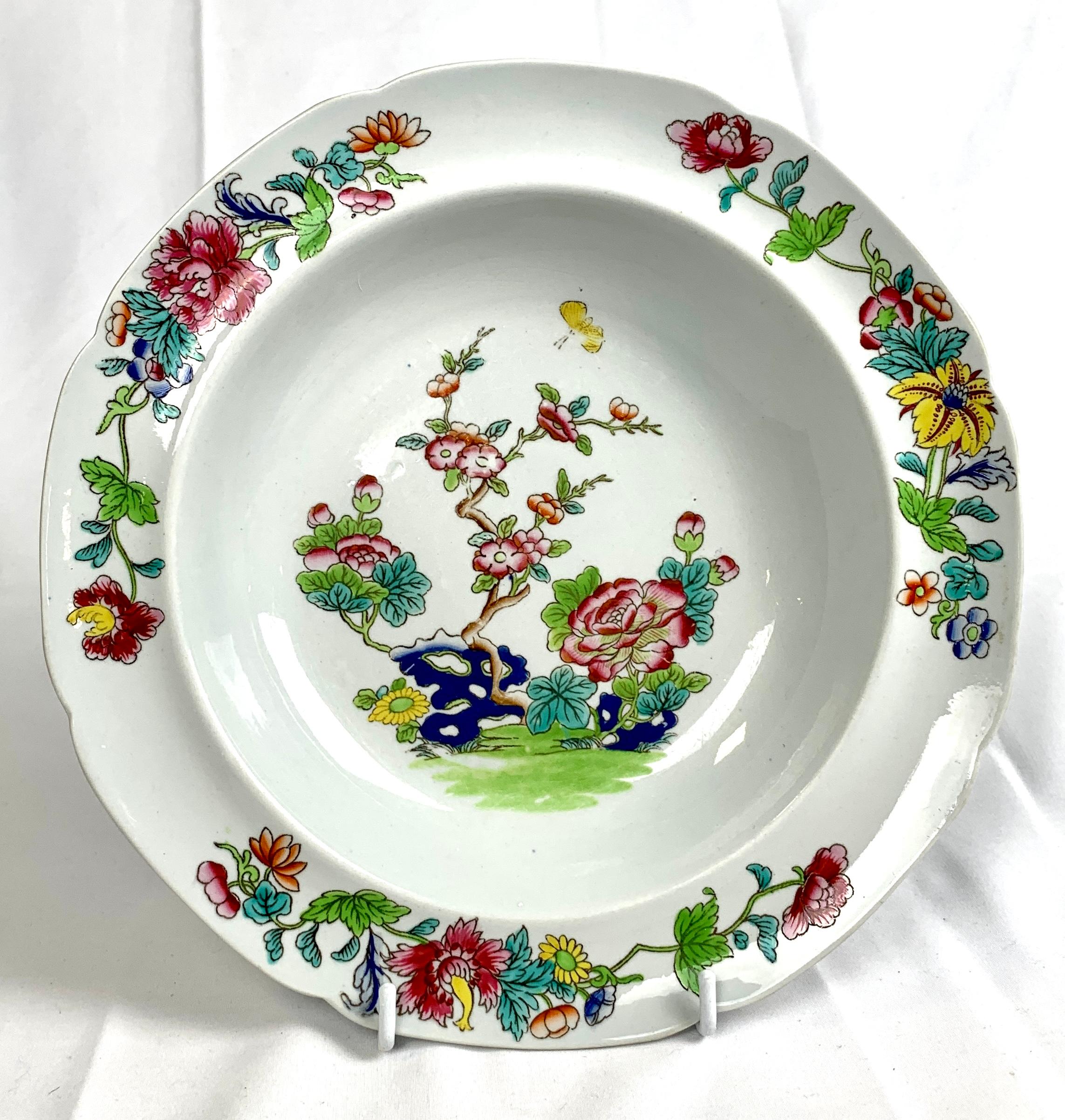 This set of six ironstone soup dishes was made in the Spode factory circa 1820.
In the center, we see a lovely garden scene with pink and purple peonies, plum blossoms, and 
a yellow chrysanthemum, all rising above cobalt-blue rockwork.
The colors