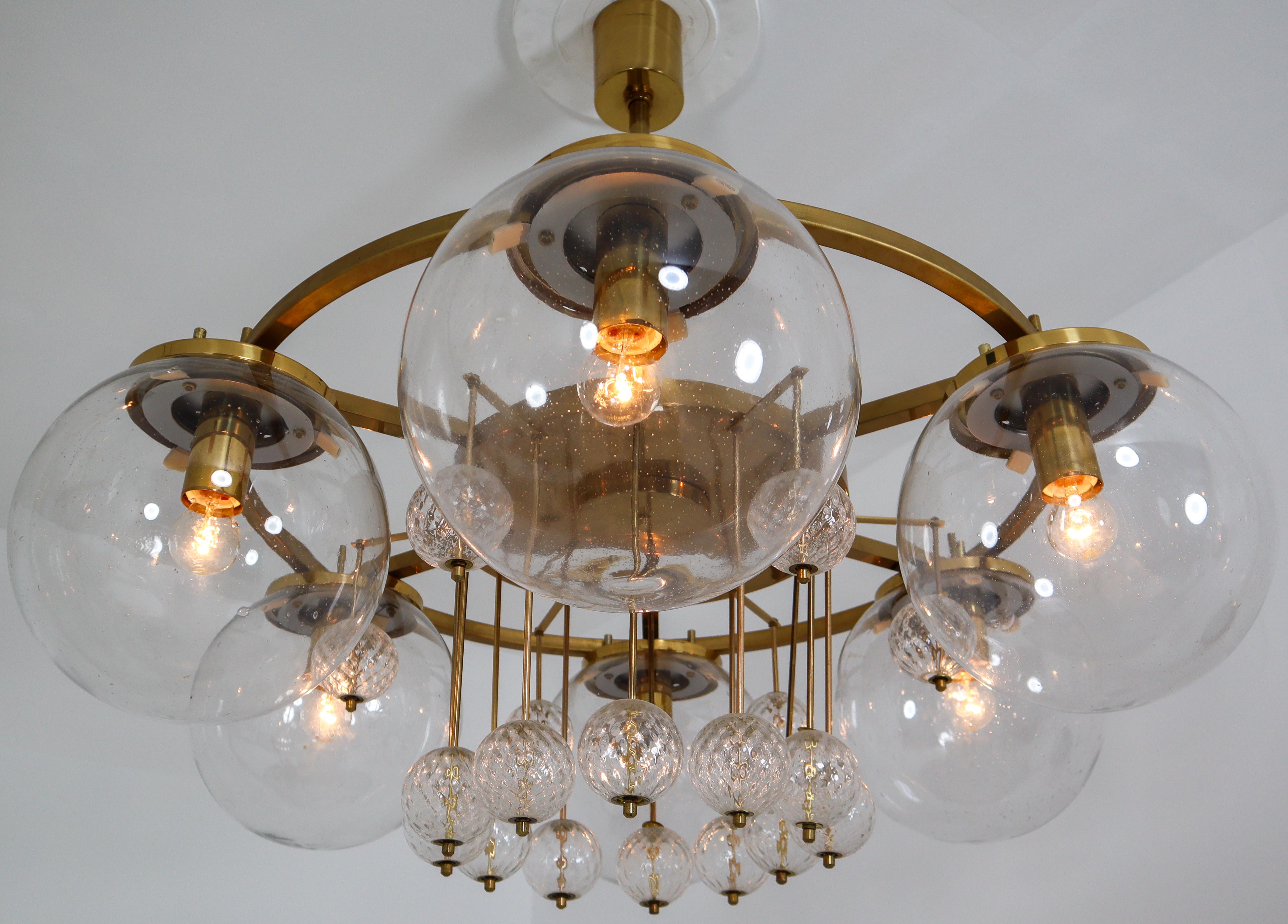 Six large hotel chandeliers with brass fixture and large hand blowed glass. These chandeliers with brass frame consist of six lights, formed in a circle, with glass shades. The pleasant light it spreads is very atmospheric. Completed with the