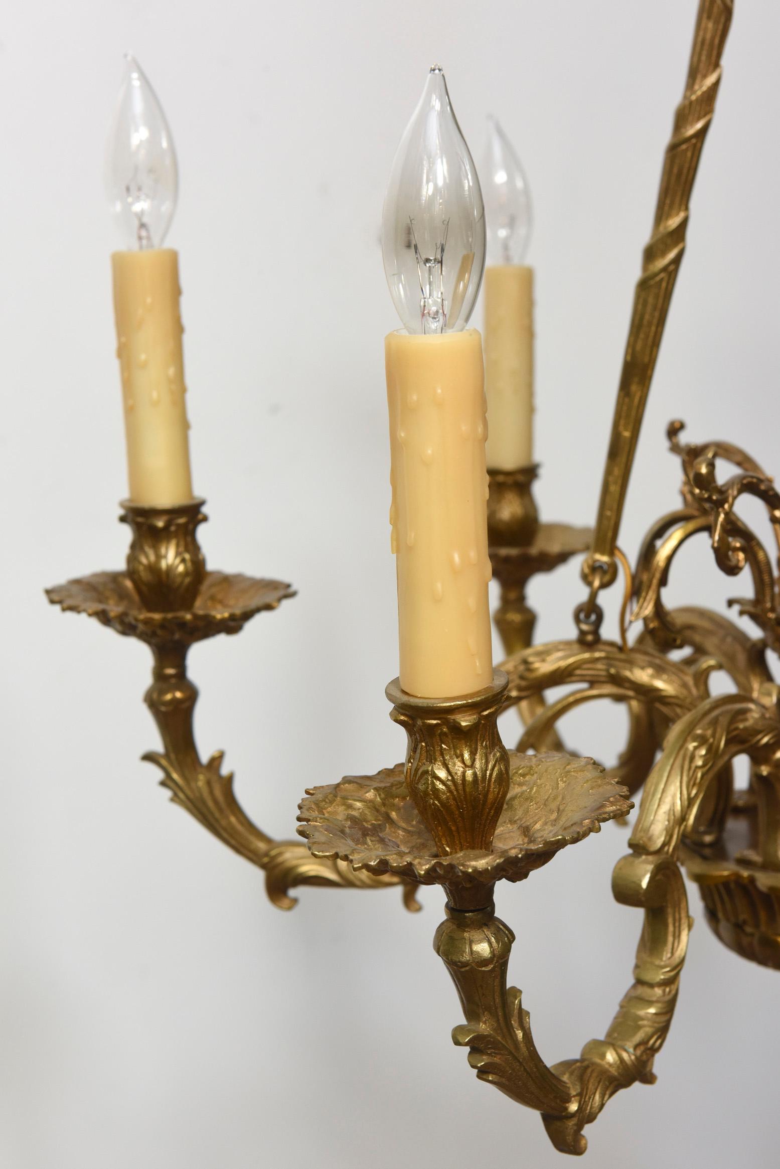 Six Arm Cast Brass Chandelier. Ornate Arms, suspended from three rods.  Mid 20th Century. Completely restored and rewired, ready to hang.

Dimensions: 
Height: 26