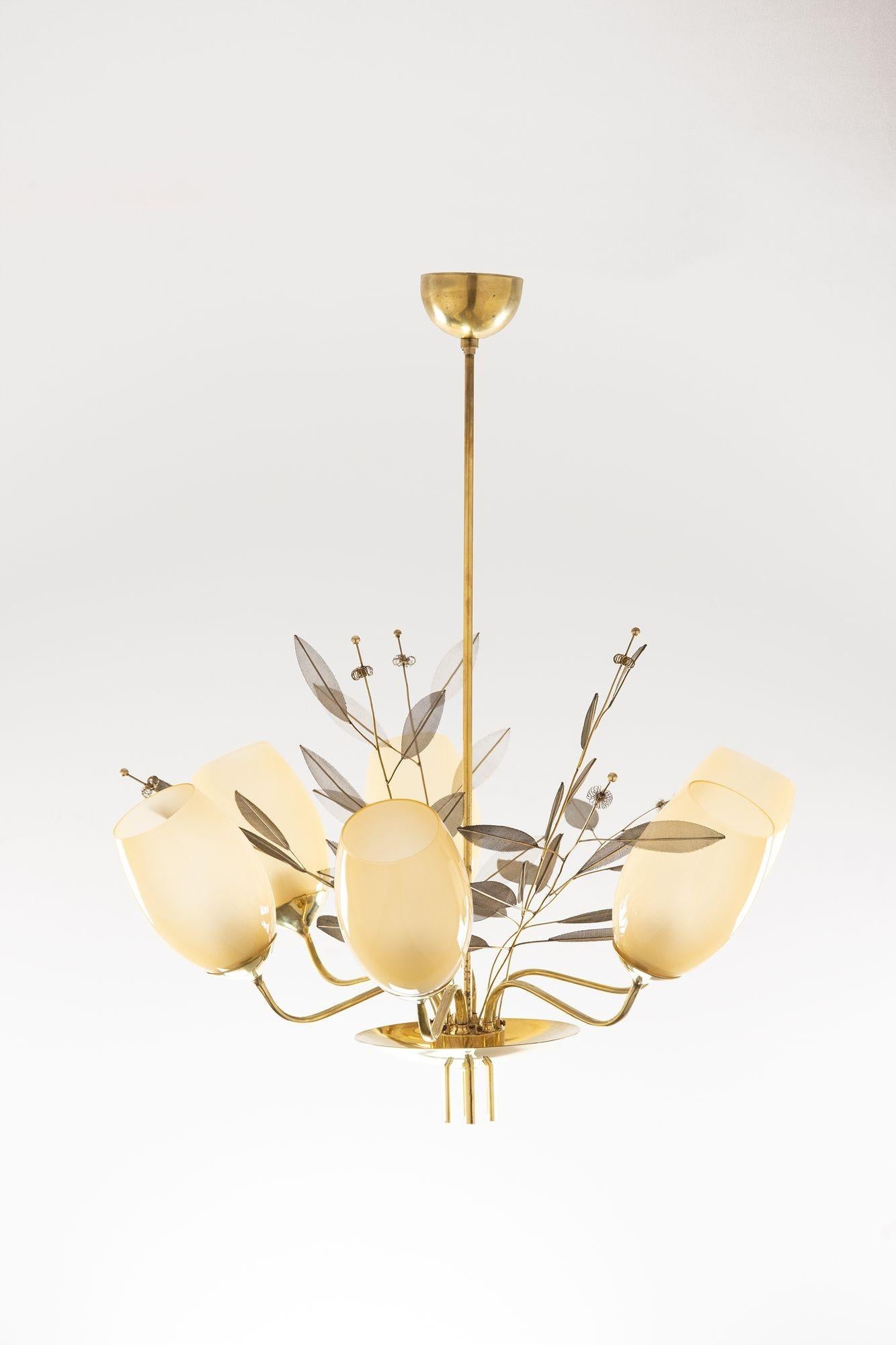 Beautiful six-light chandelier model 9029/6 designed by Paavo Tynell for Taito Oy/Idman c. 1950 Finland. The chandelier has been recently polished constructed of brass and has six almond color glass shades.