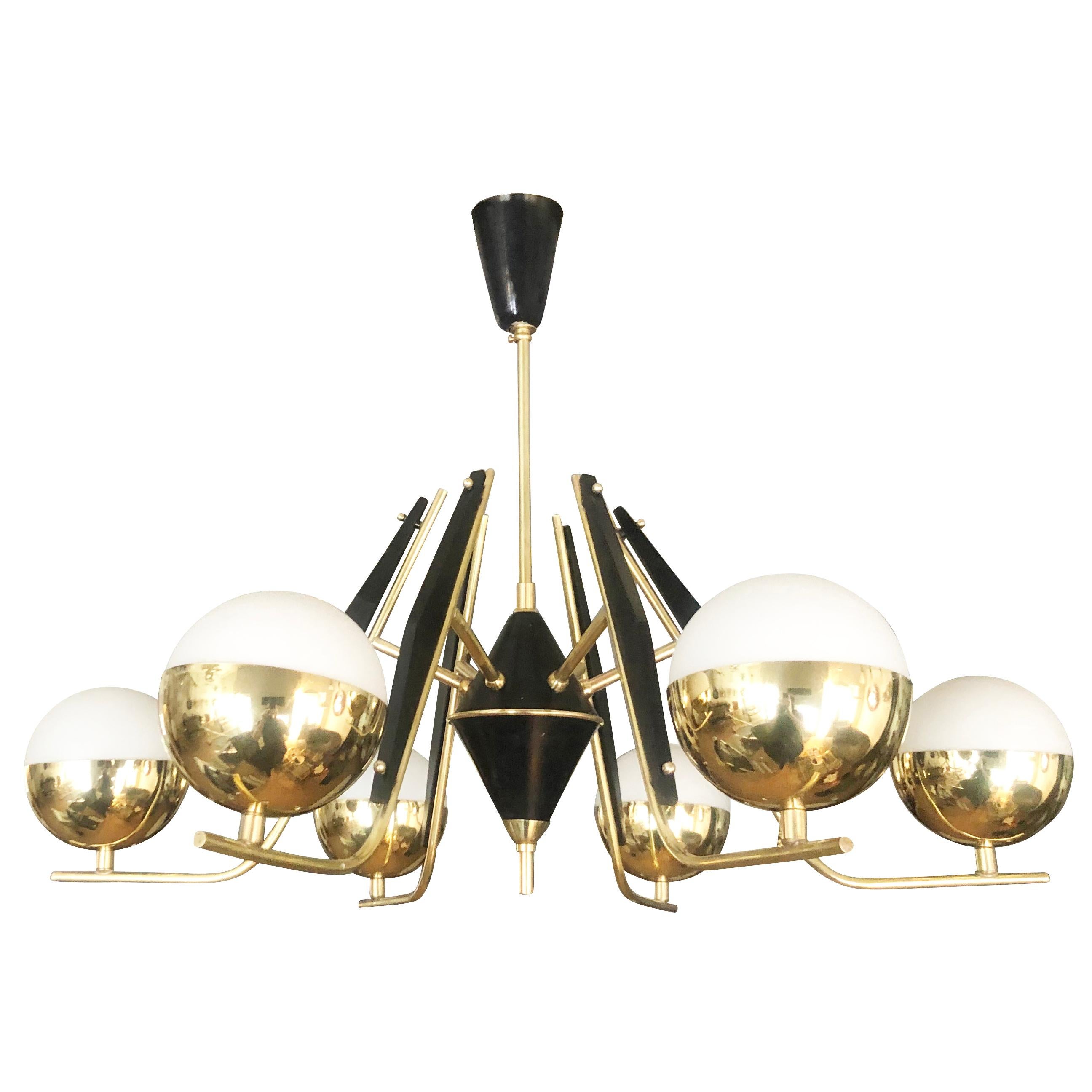 Italian midcentury chandelier in the manner of Stilnovo featuring six arms ending in round satin glass shades. The frame is all brass with some parts lacquered black. Height of stem can be changed upon request.

Condition: Excellent vintage