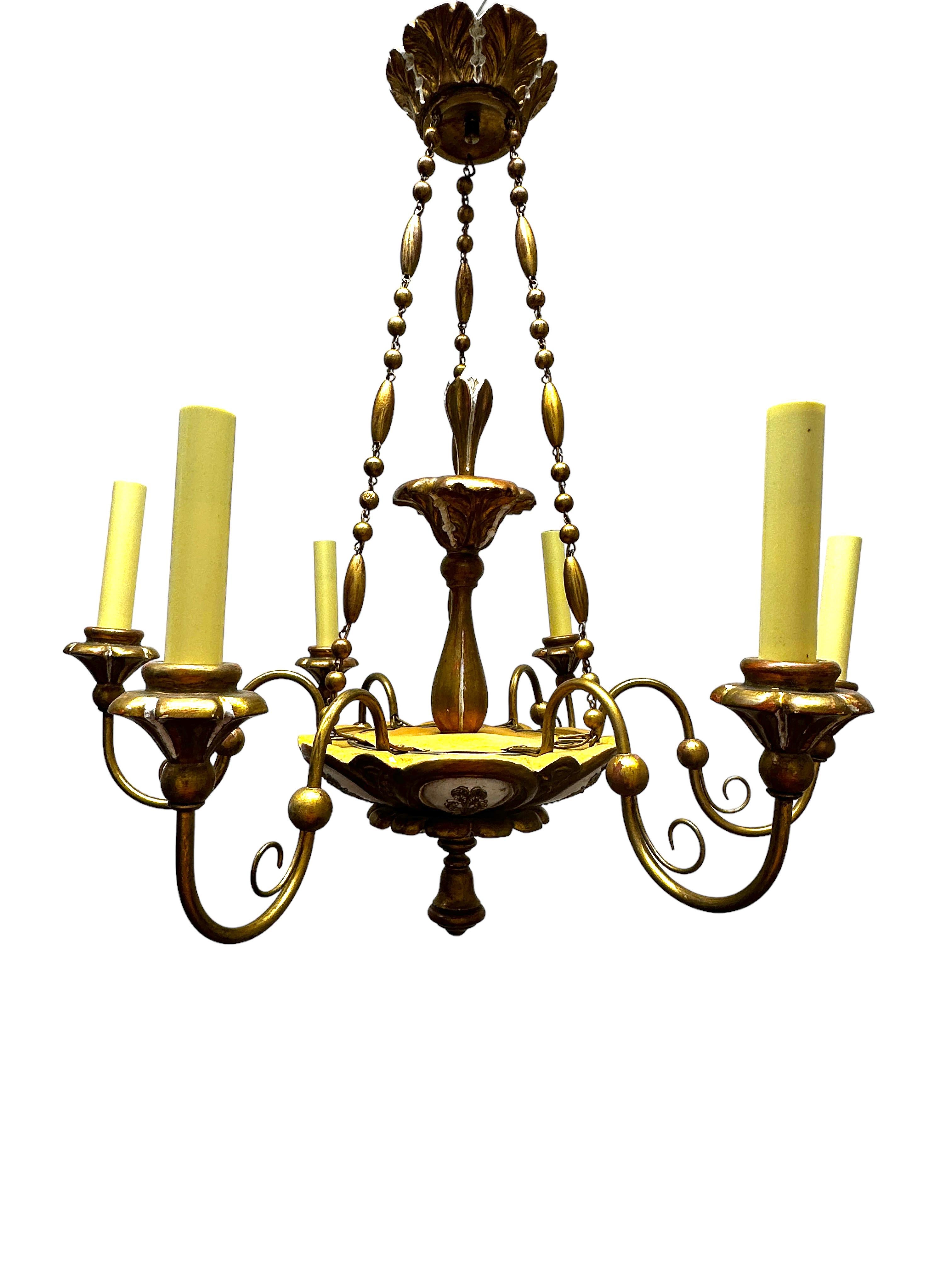 Add a touch of opulence to your home with this charming chandelier! Perfect chippy white, gilt wood and hand carved chandelier to enhance any chic or eclectic home. We'd love to see it hanging at a dinning place as a charming welcome. The chain with