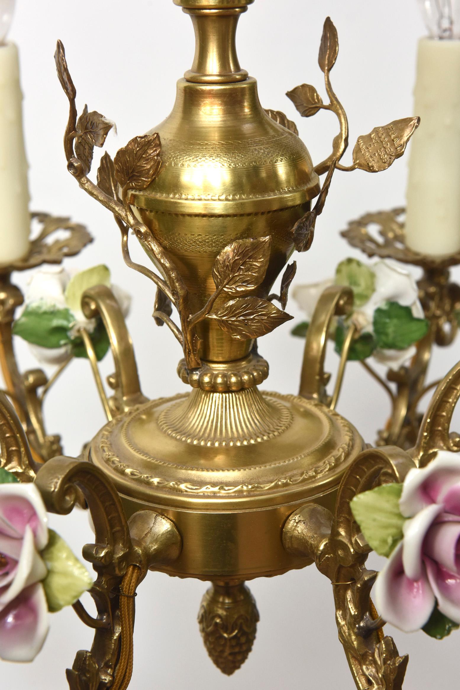 Ornate gilt chandelier with porcelain roses. Six lights. Completely rewired and restored, ready to hang.

Dimensions: 
Height: 20