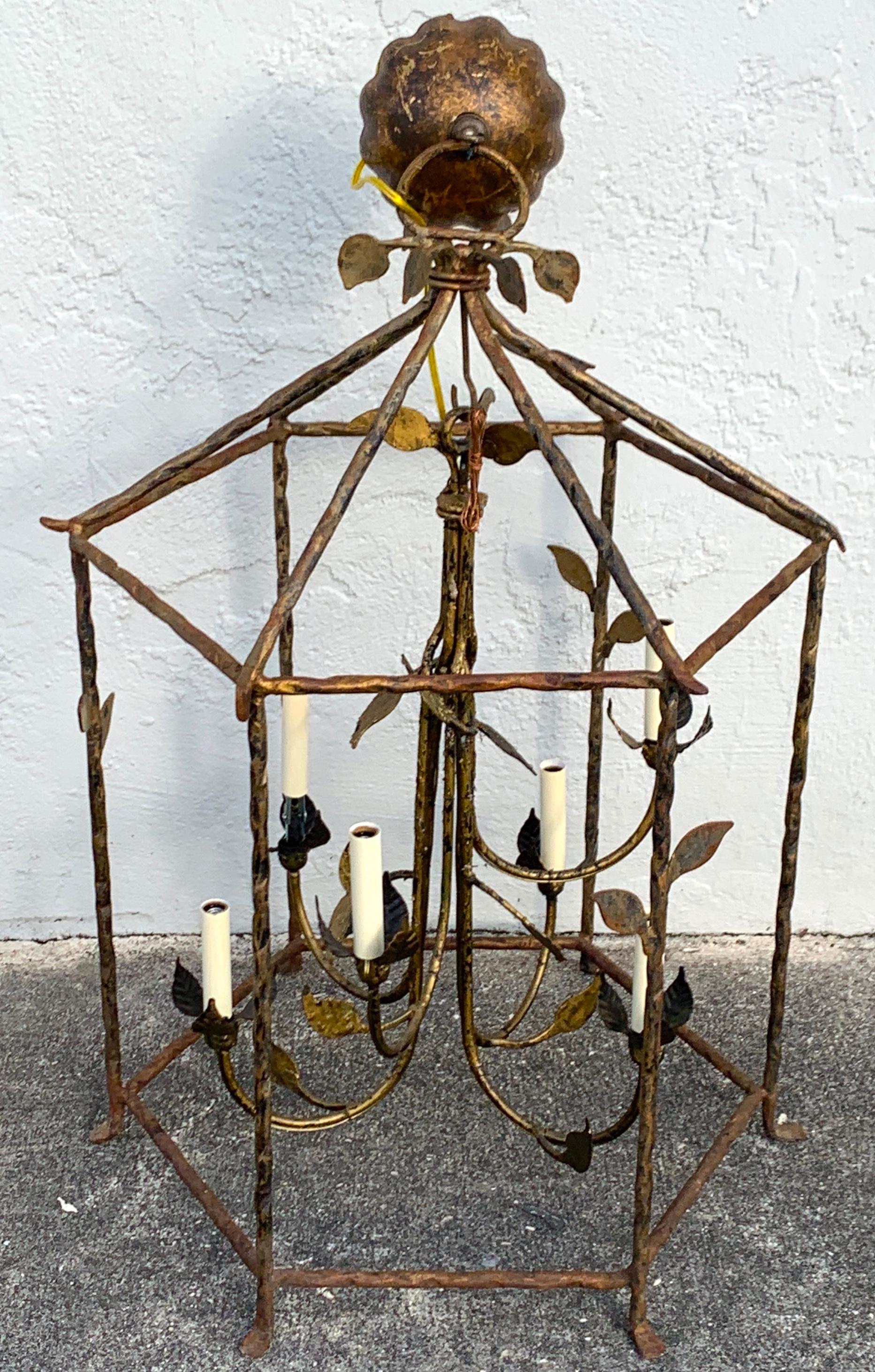 Six light gilt iron lantern in the style of Giacometti, of hexagonal form with an interior alternating tapering six light 24
