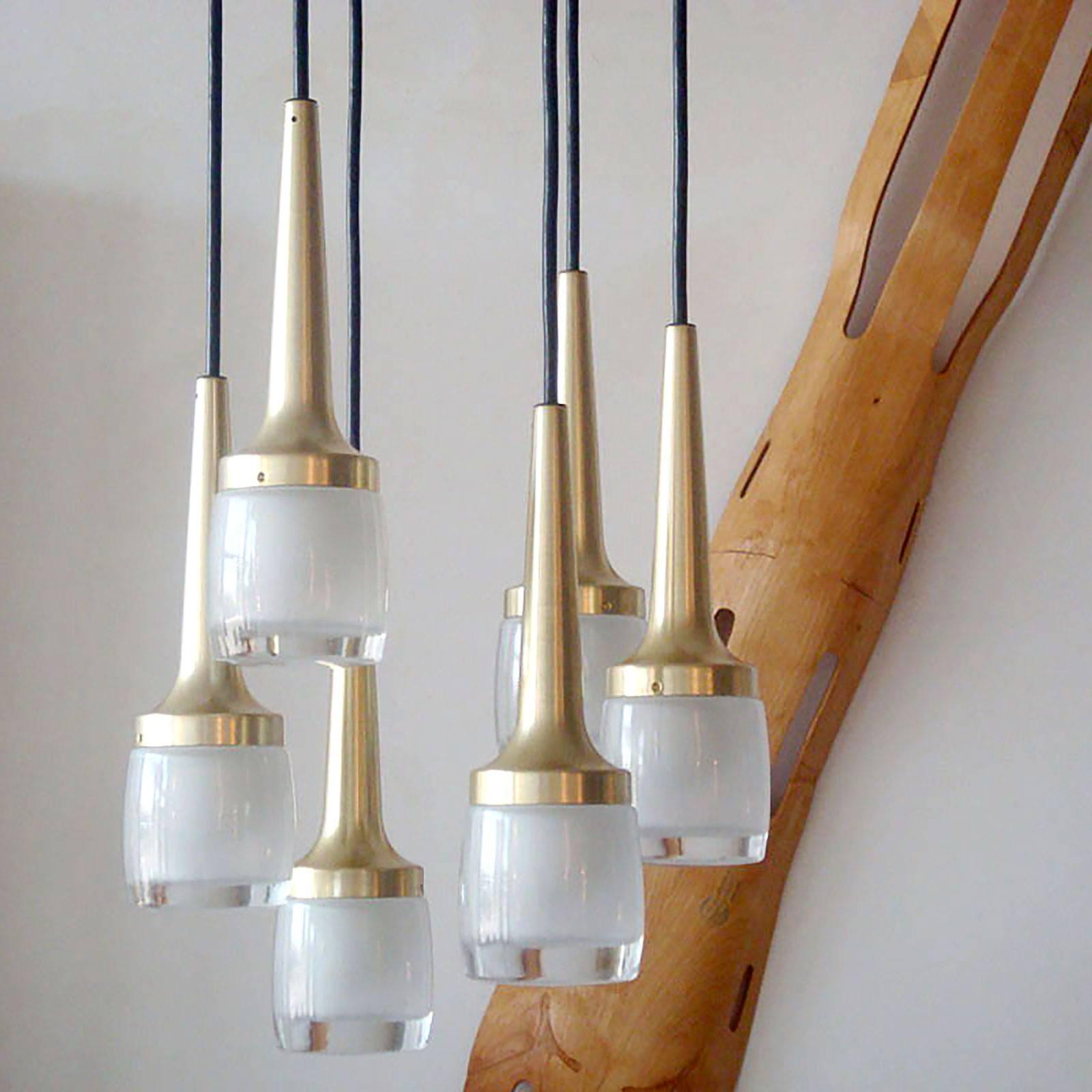 Stunning chandelier by Staff Leuchten, Germany with six brushed bras-plated hanging lights encased in heavy molded glass with inside frosting, lengths and configuration adjustable, currently in a matching square brass-plated canopy, wired for US