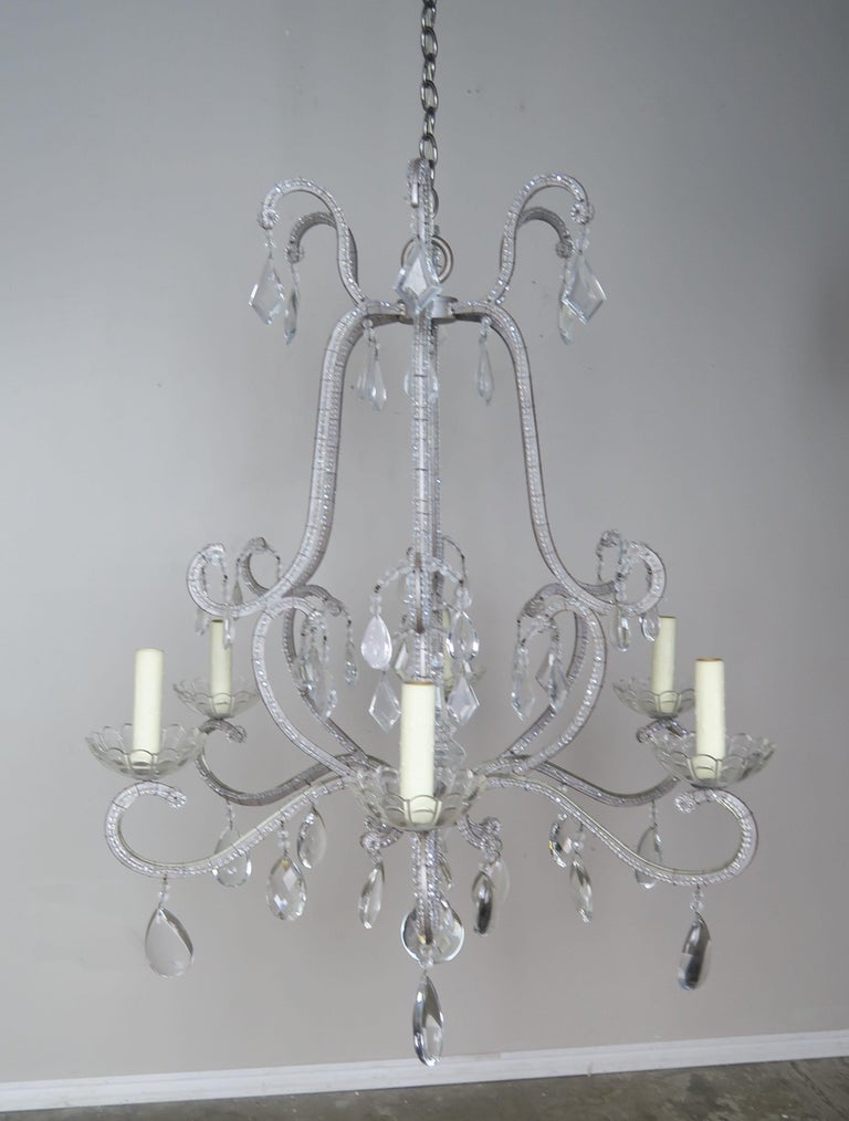 Six-light Italian style beaded crystal chandelier adorned with almond shaped and kite shaped crystals throughout. The chandelier is newly rewired with cream drip wax candle covers. Includes chain and canopy.