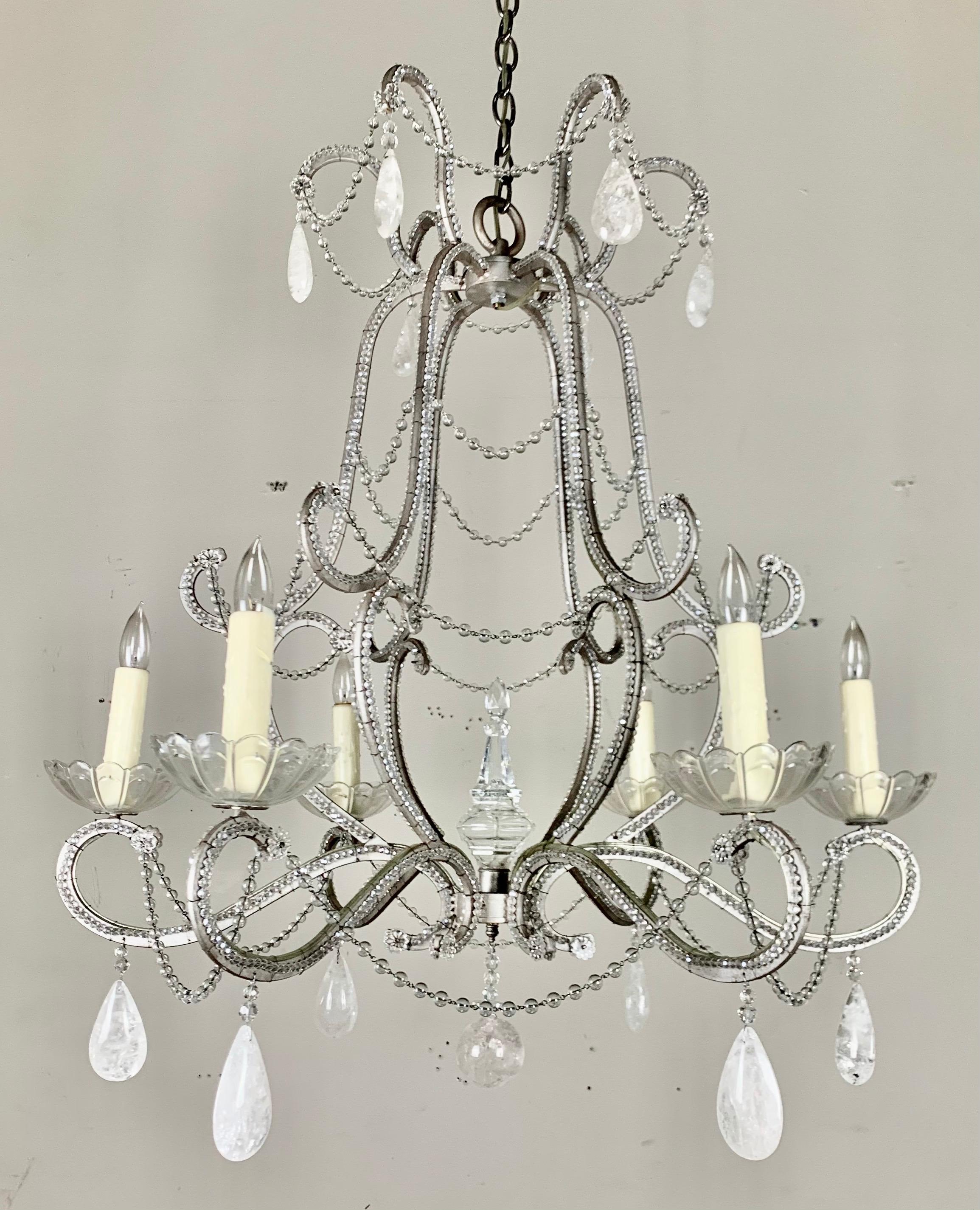 Six light rock crystal beaded silvered metal chandelier with beaded frame. The chandelier is adorned with almond shaped rock crystals throughout. The elegant fixture is newly rewired with drip wax candle covers and includes chain and canopy.