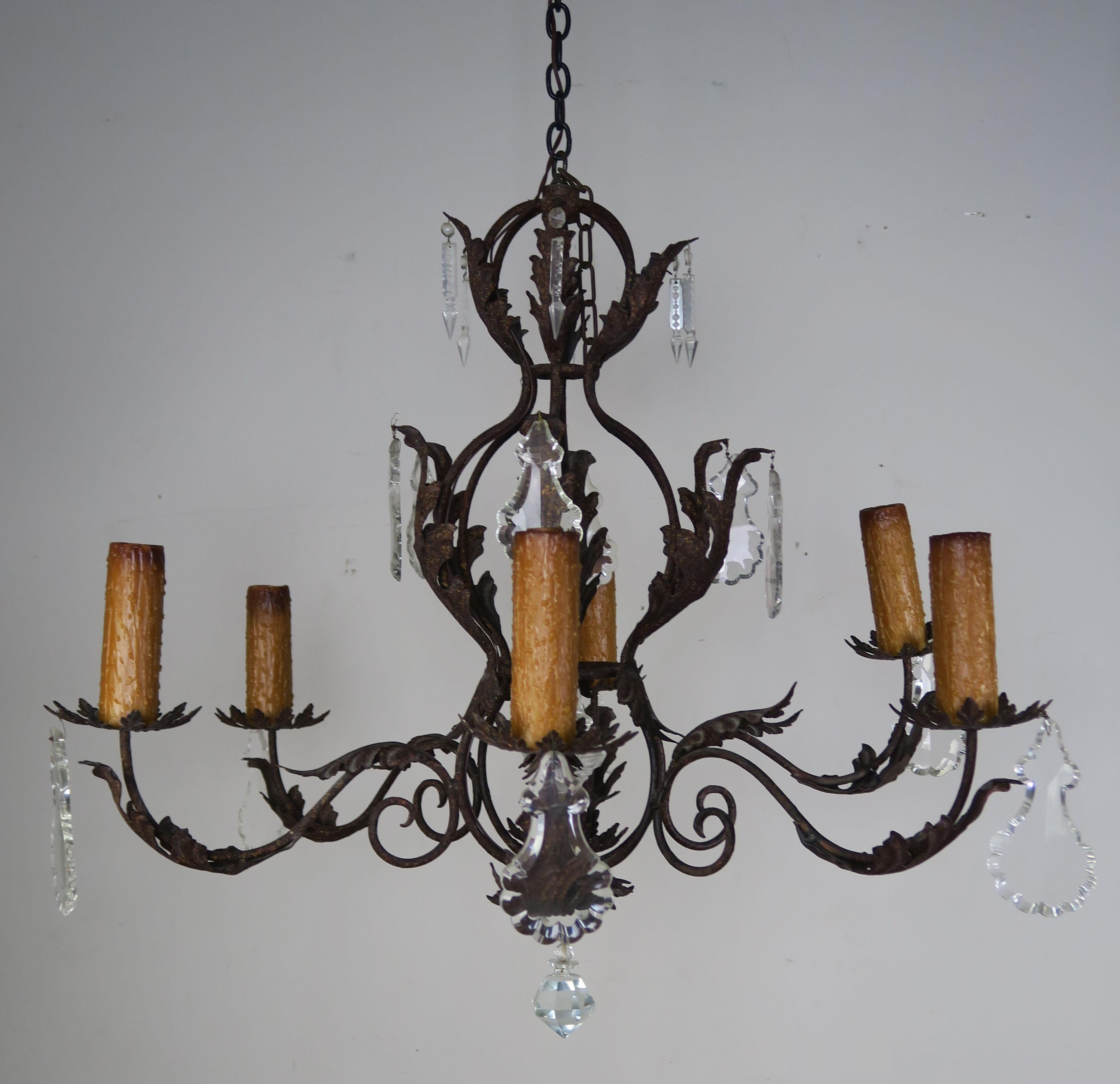 Six light Spanish style wrought iron chandelier with large pendulum and sphere shaped crystal drops.