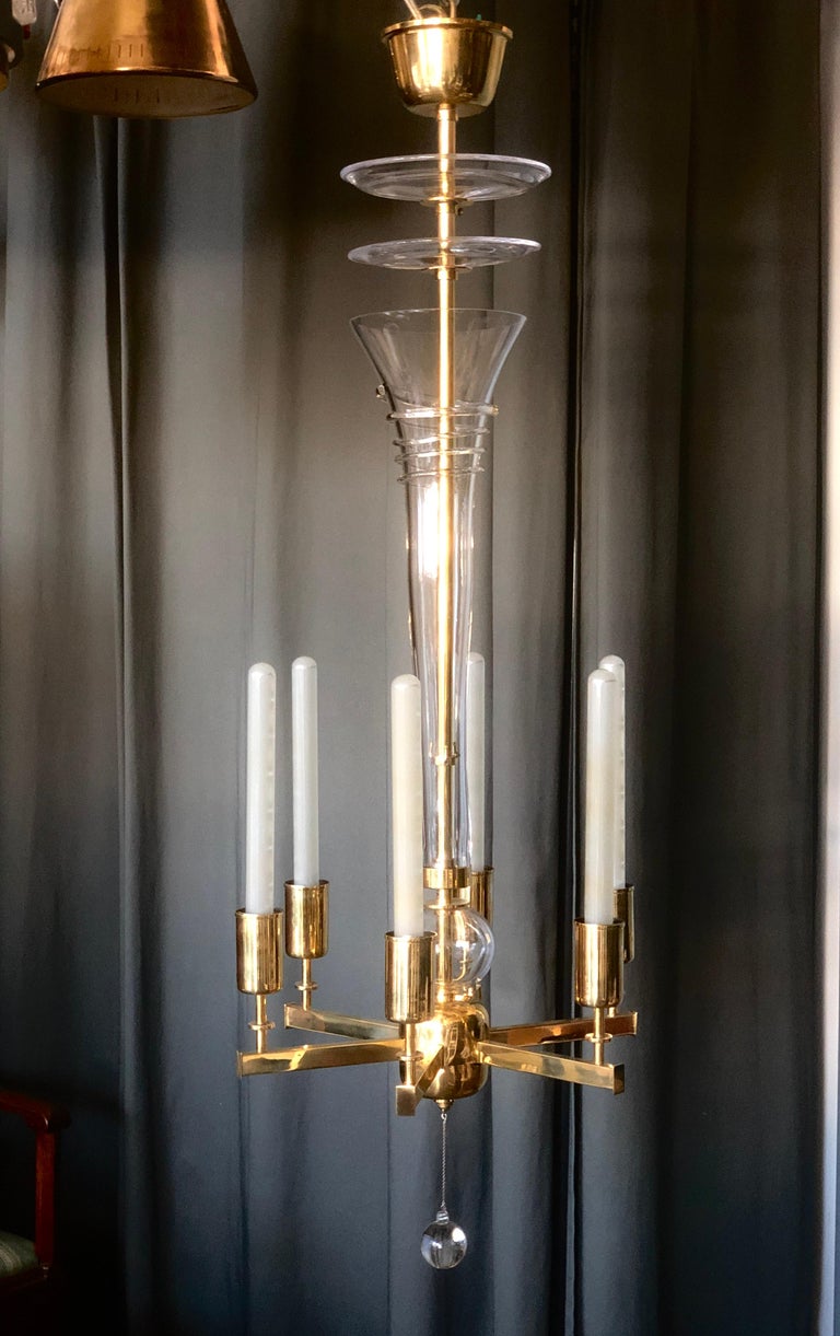 Rare, six lights chandelier designed by Paavo Tynell for Taito Oy, Finland. Circa 1930th. This chandelier was designed for banquet hall of Helsingin Suomalinen Yhteiskoulu (SYK) in Helsinki. Acquired form this place by previous owner. Polished brass