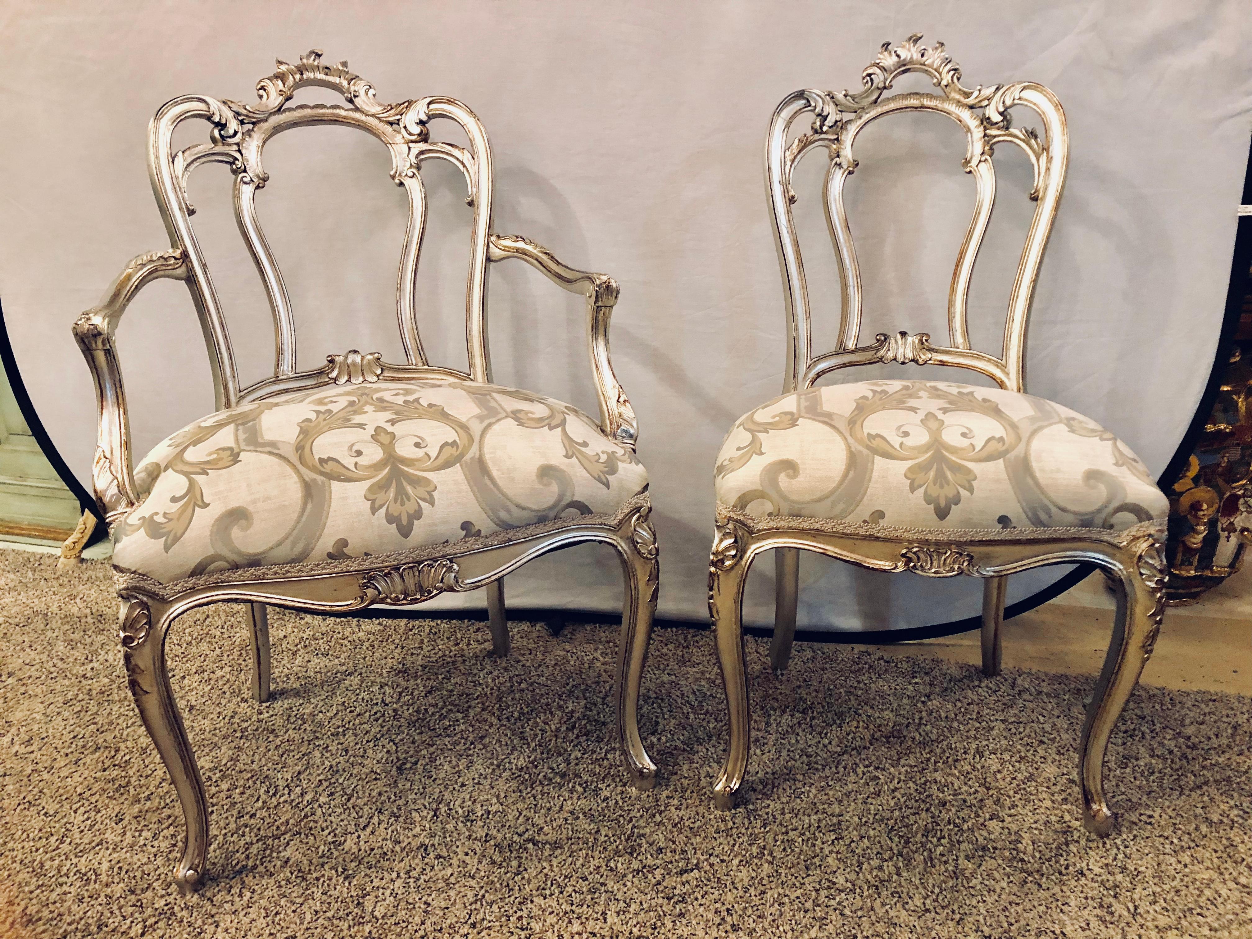 Fine set of six Louis XV Maison Jansen style silver gilt recently refinished and upholstered dining-room chairs. A pair of arm and four side chairs make this fantastic set of silver leaf over red clay painted carved dining chairs a stunning example