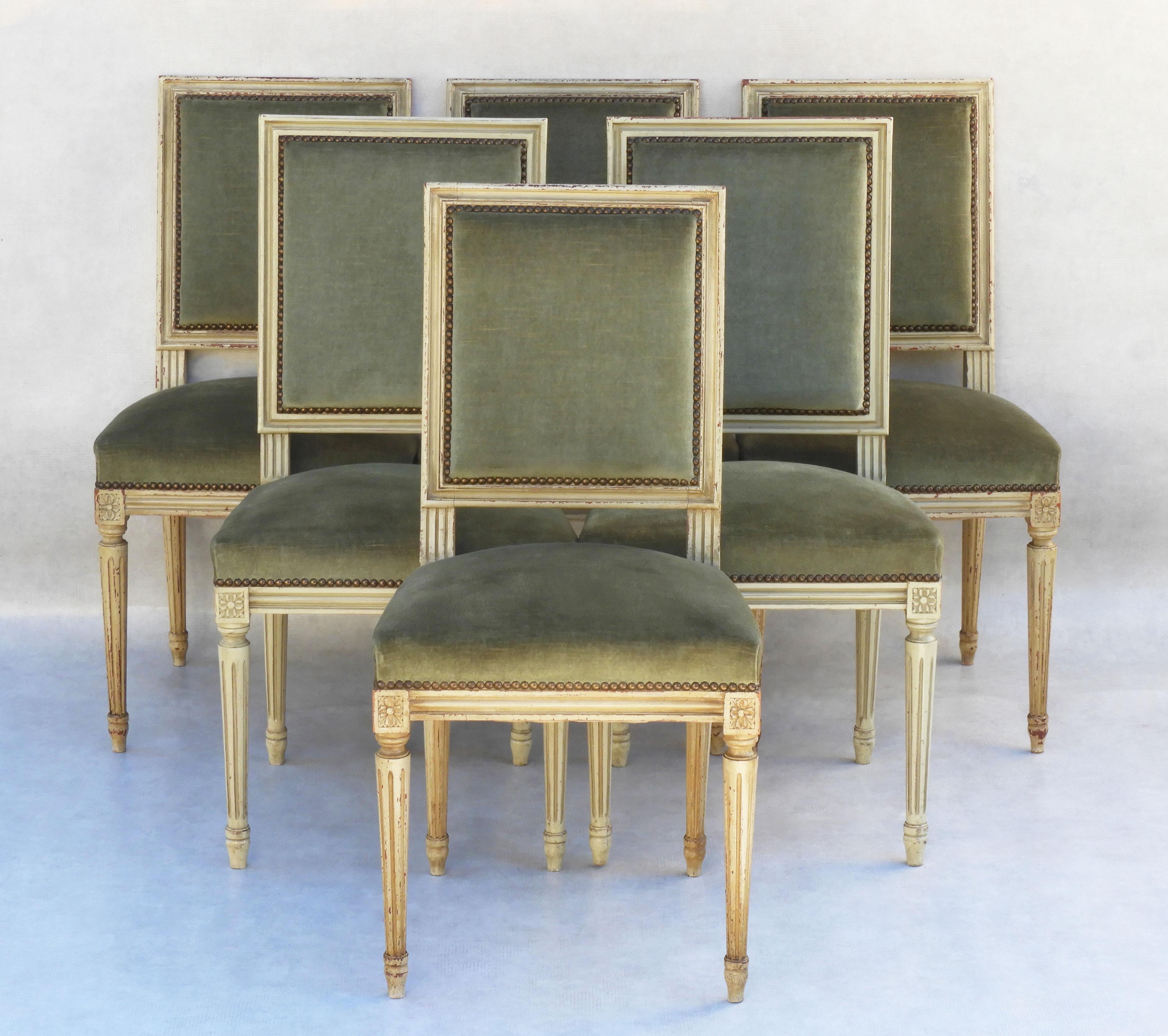 Set of six French dining chairs, mid 20th century Louis XVI revival C1960                                
All original velvet velour studded upholstery on lightly distressed painted finish frames.
Heavy, well-made chairs, sturdy, solid and sound. 