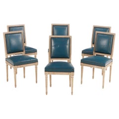 Six Louis XVI style painted and carved dining chairs in old blue leather C 1940