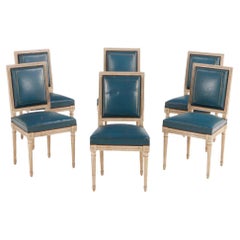 Six Louis XVI style painted and carved dining chairs in old blue leather C 1940 Six Louis XVI style painted and carved dining chairs in old blue leather C 1940